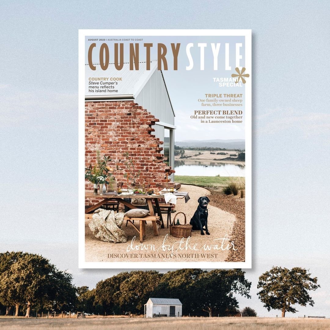 Leading Rein | Cover of Country Style Magazine featuring a rustic brick wall with a styled wooden picnic table and benches in the foreground. A black dog sits beside a picnic basket. Rural Tasmania scenes in the background.