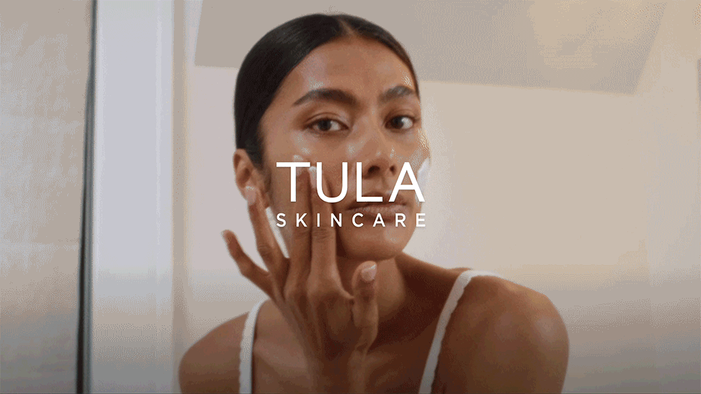 animated gif of lady rubbing in TULA moisturiser into her skin