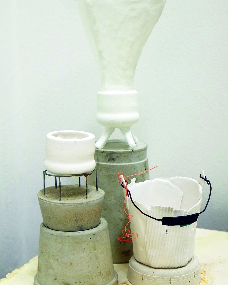 Cast concrete, porcelain and wire.