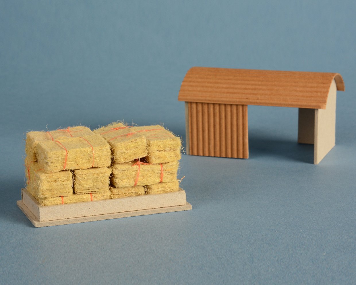 Handmade straw paper, baler twine, greyboard and corrugated card. 6cm x 5cm x 14cm.