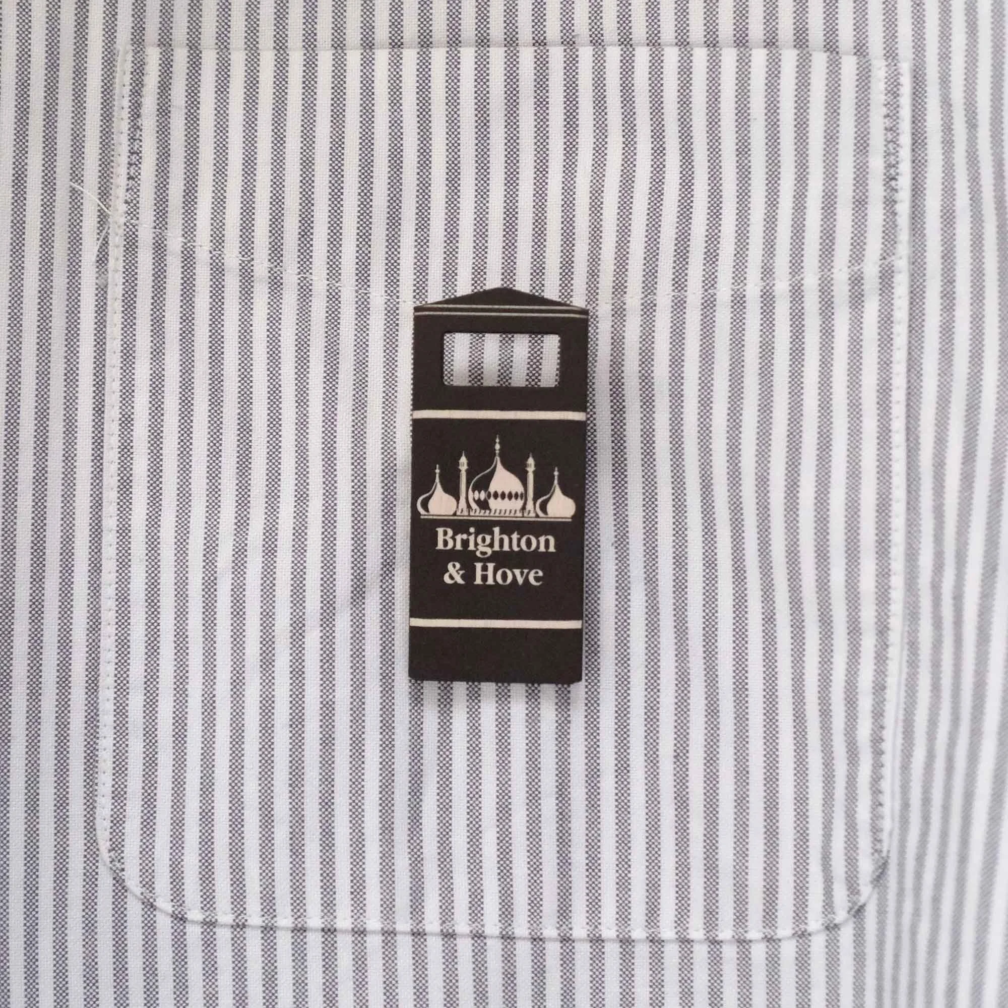 Brighton bin badge on a stripy shirt pocket