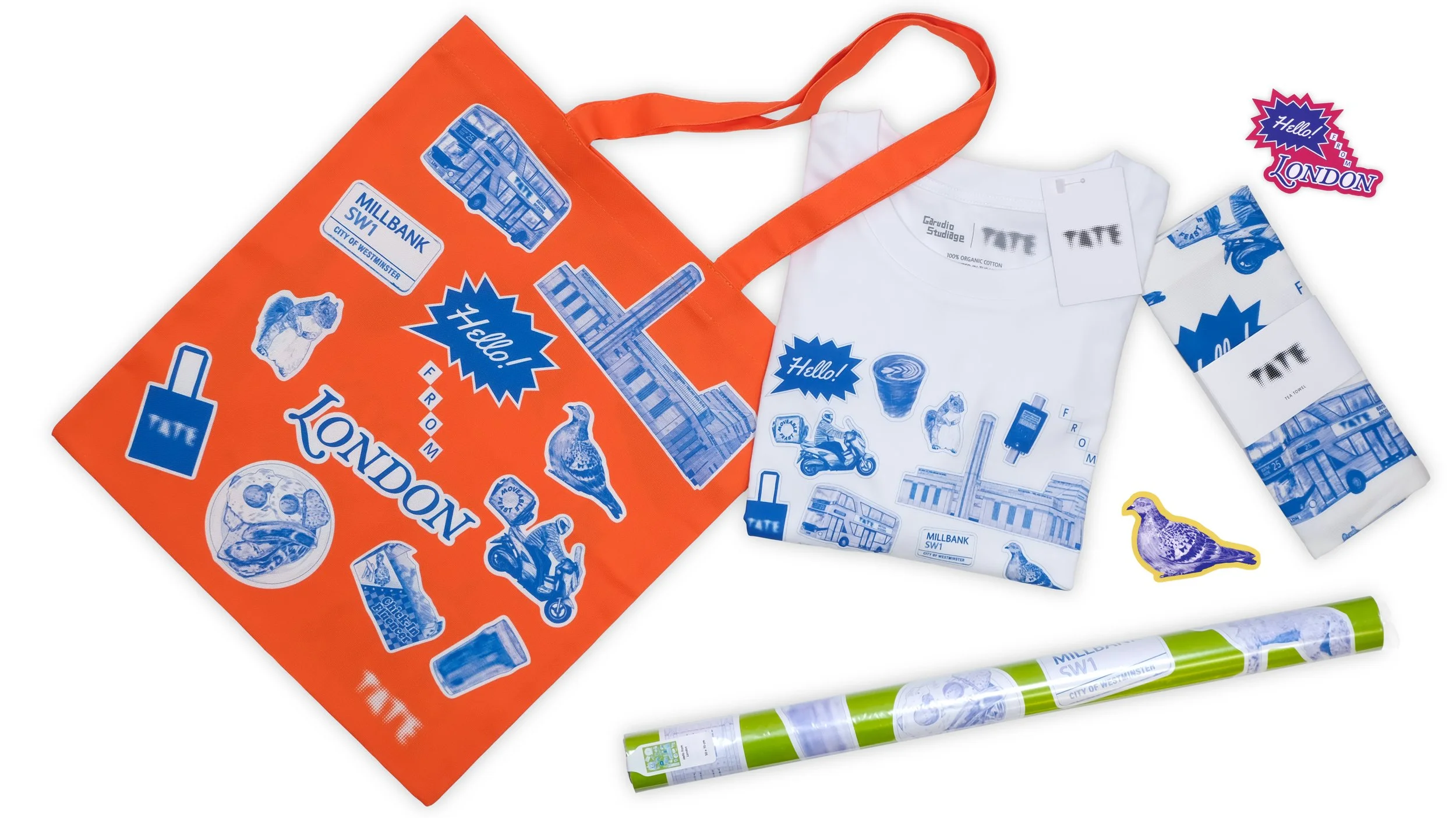A white T-shirt, an orange tote bag, a rolled-up poster, and a yellow sticker shaped like a pigeon, all featuring blue-and-white London-themed graphics and text.