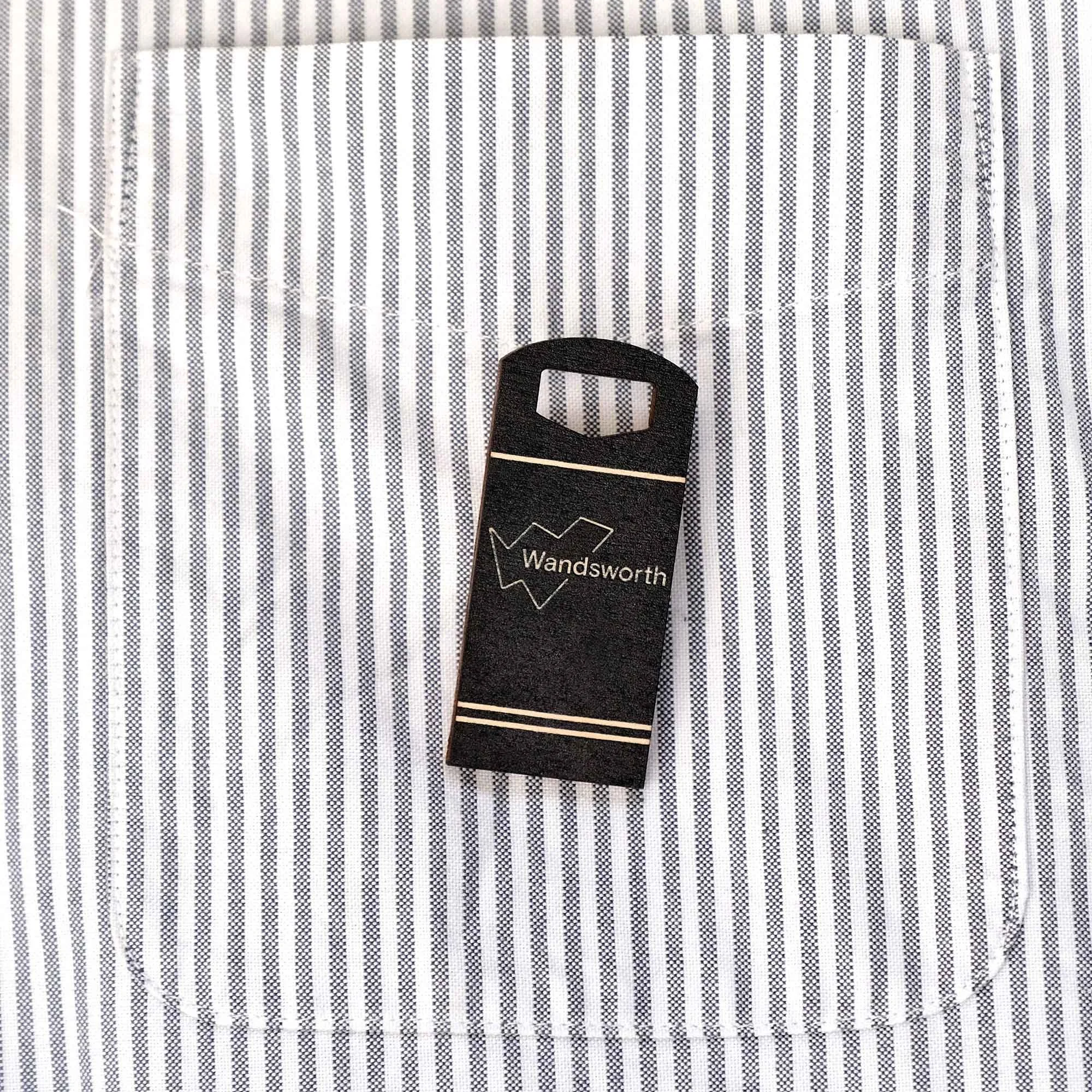 Wandsworth bin badge on a stripy shirt pocket