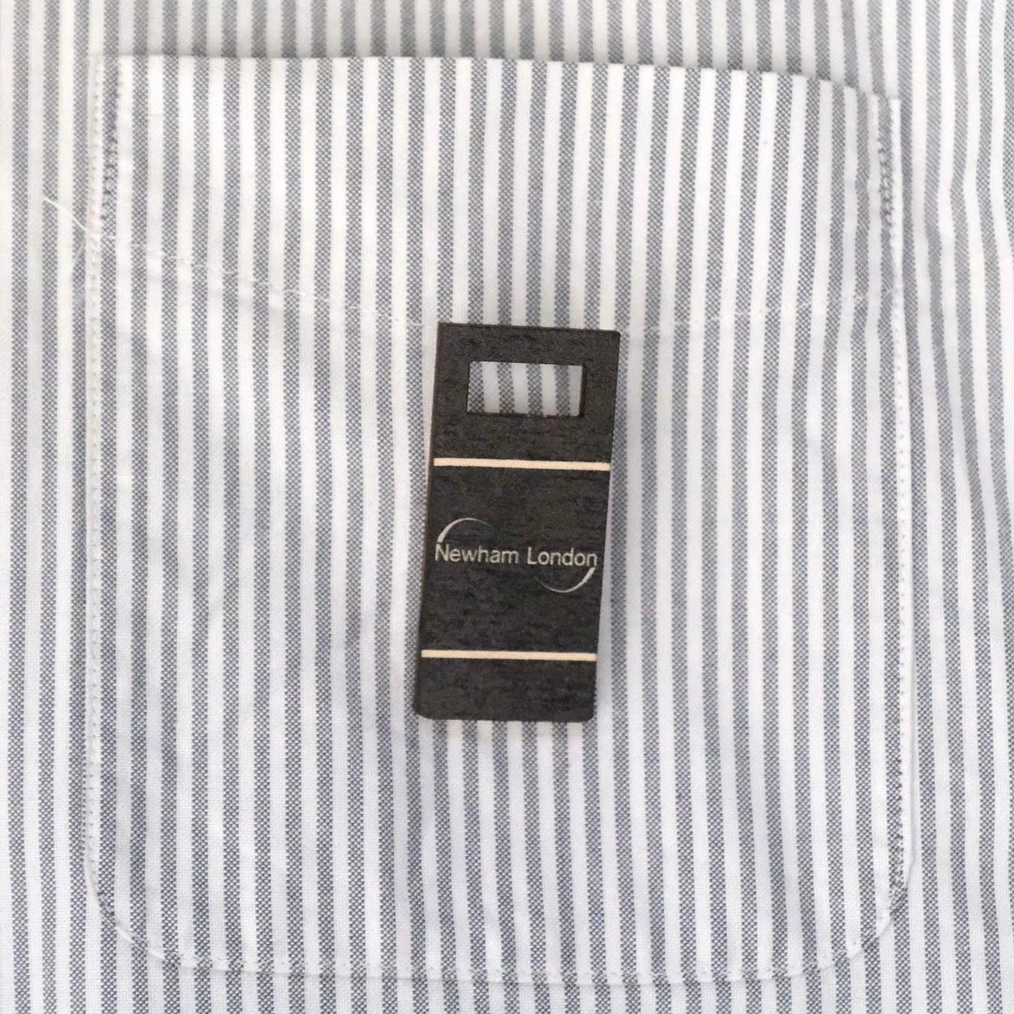Newham bin badge on a stripy shirt pocket