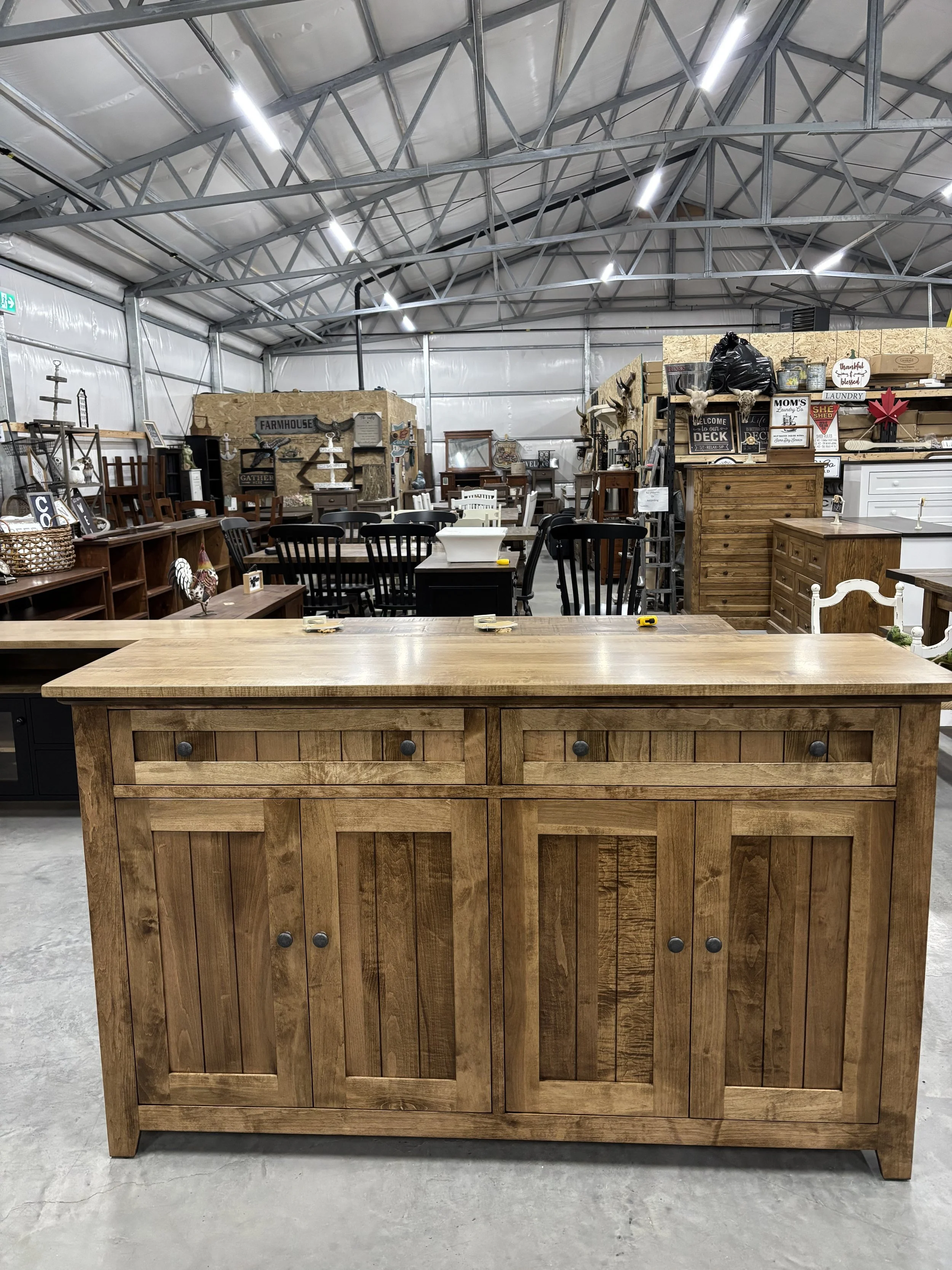Wooden sideboard with a decorative sign reading 'The Gathering Place where friends become family.'
