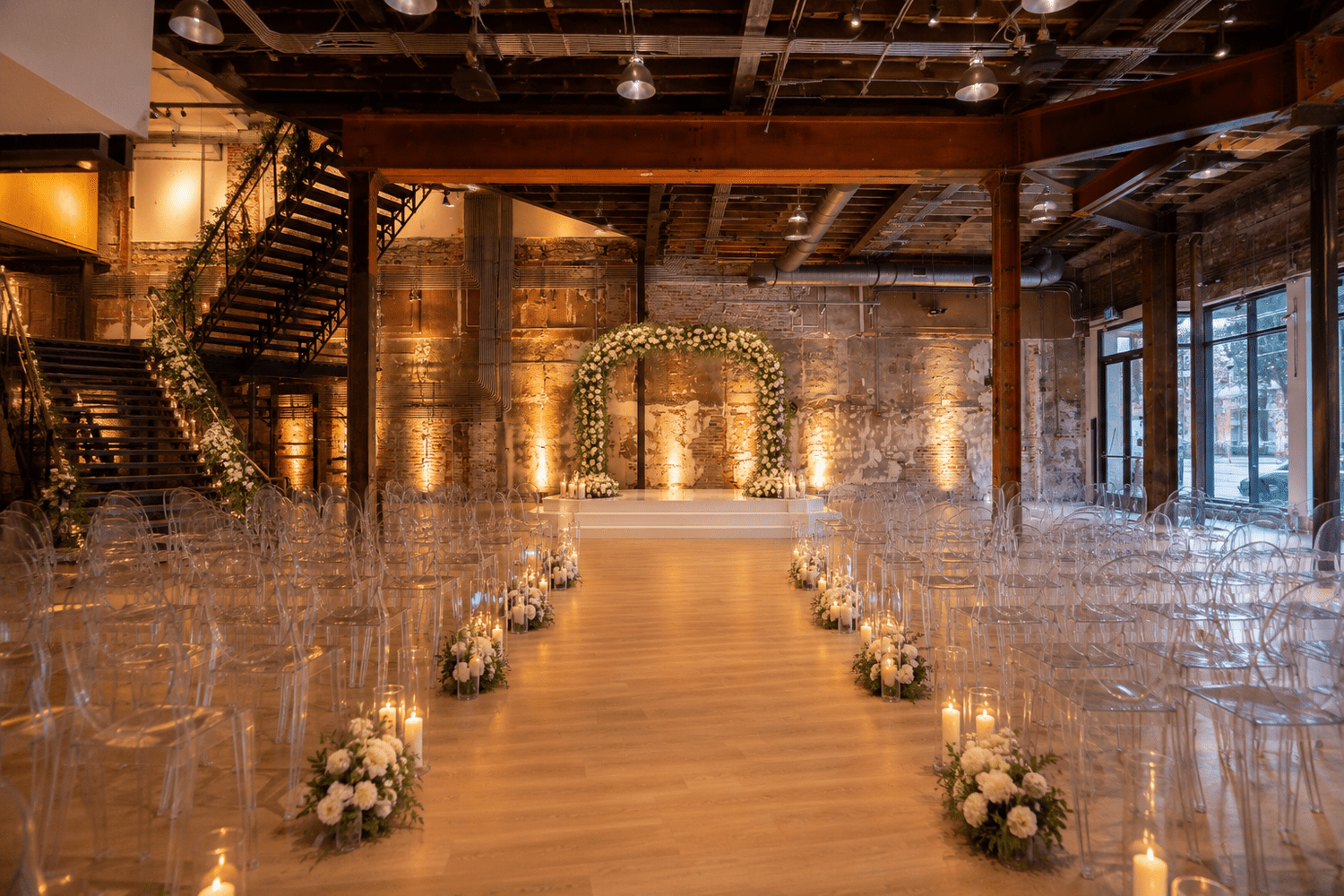 Candlelit wedding aisle and floral ceremony arch