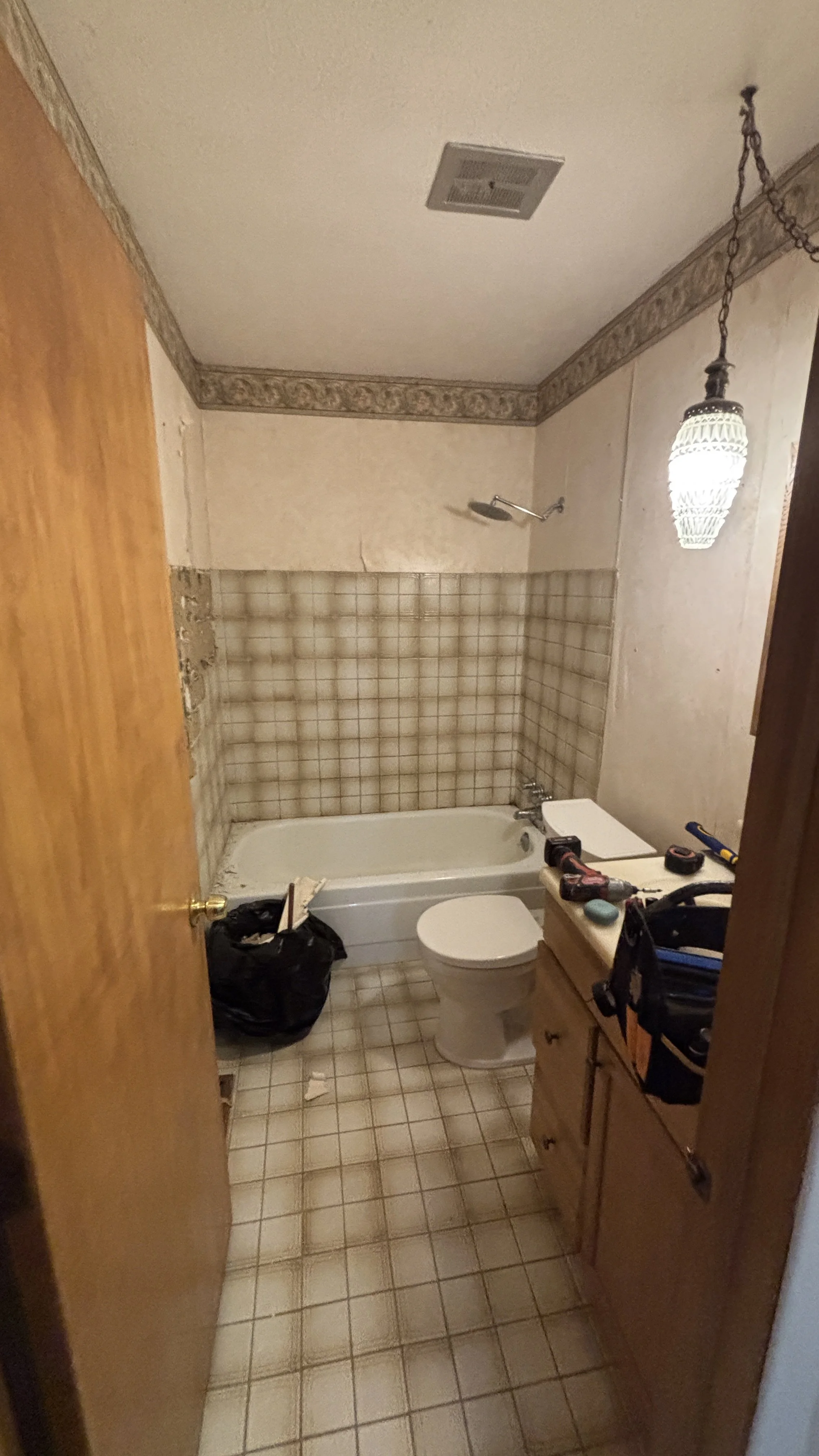 before and after new tub surround grab bars handyman bathroom updates remodel vanity flooring