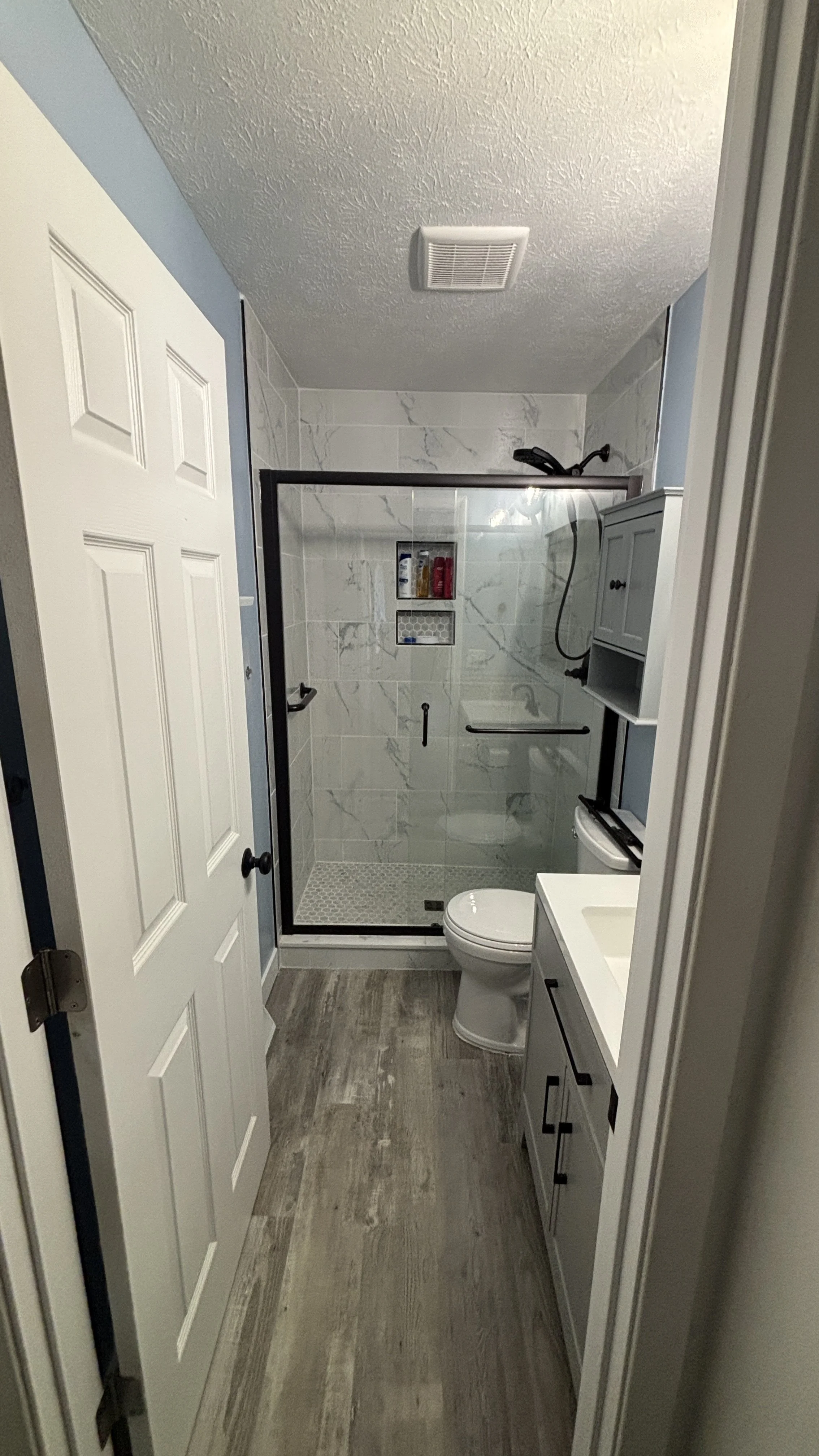 Bathroom remodel tile bathroom new flooring before and after handyman new vanity light fixtures exhaust fan doors