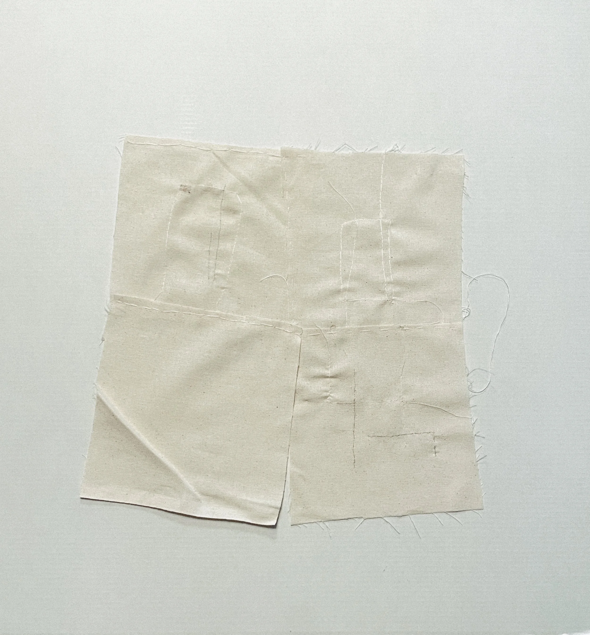 Layered cloth and hand stitching arranged as an unfolding sculptural form.