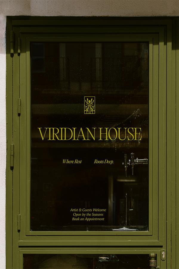 A green door has Viridian House wordmark and logo with hours of operation