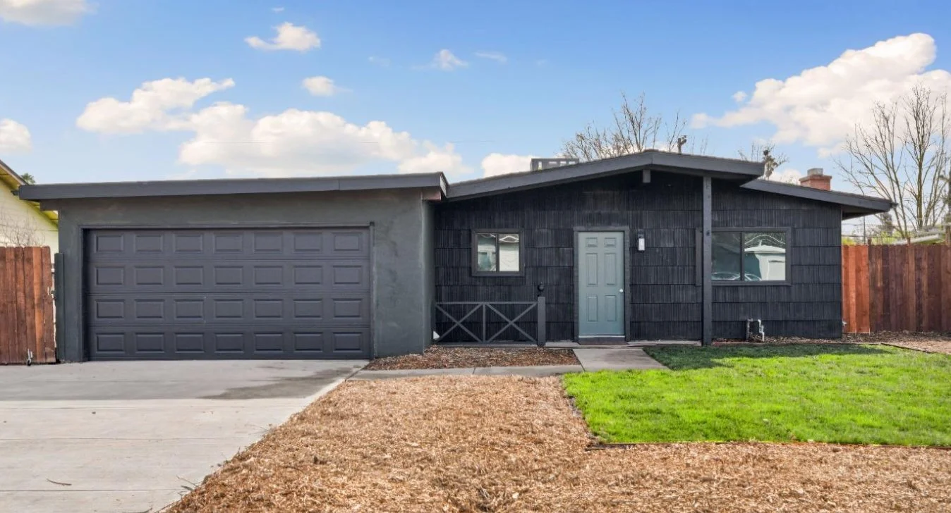 Front view Classic Sacramento Mid Century modern home. Gable roof, grey paint, 2 car garage.