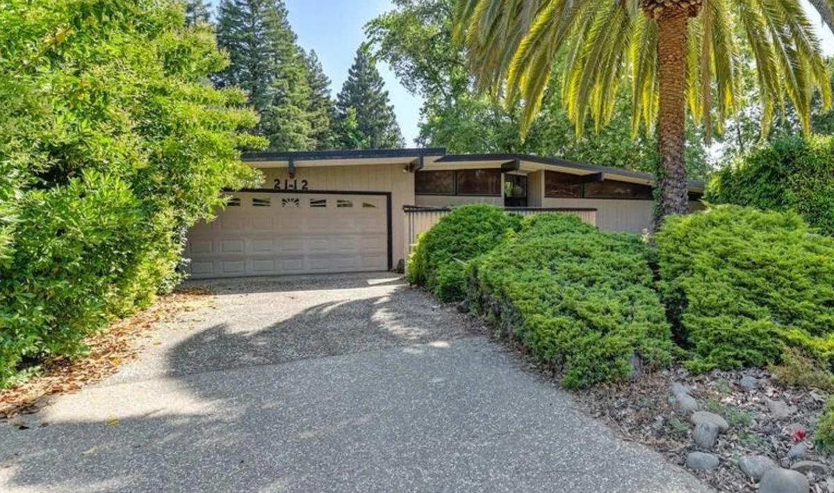 Streng Bros Front Gable home with Palm tree in front yard