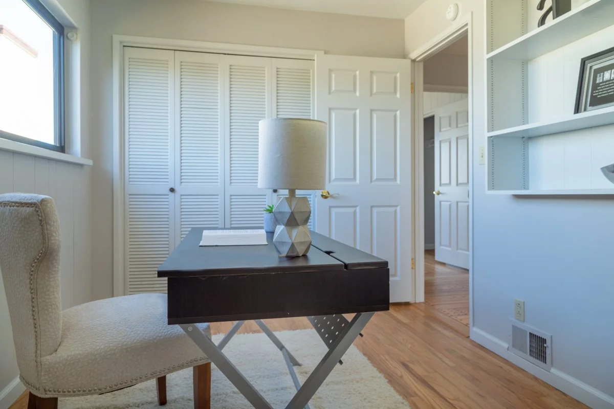Desk in office with bookshelves.