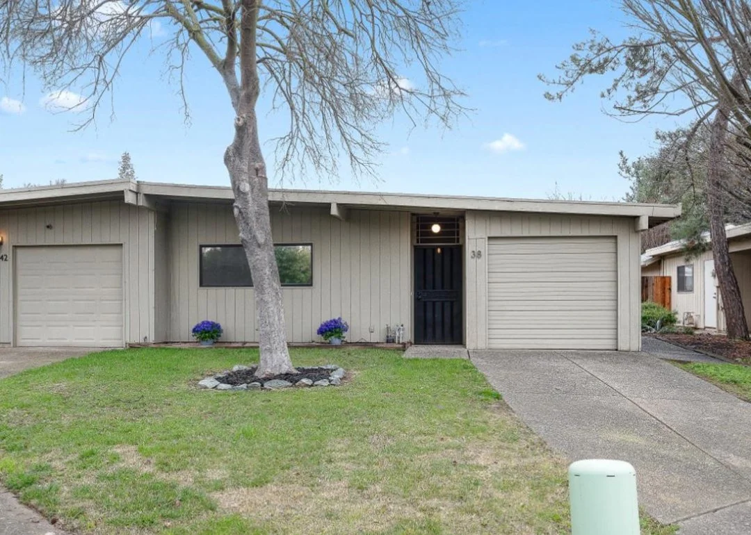 Beige Mid Century Modern halplex with  one car garage.