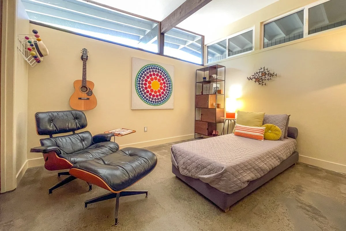 Bedroom with Eames lounge, clerestory windows, guitar.