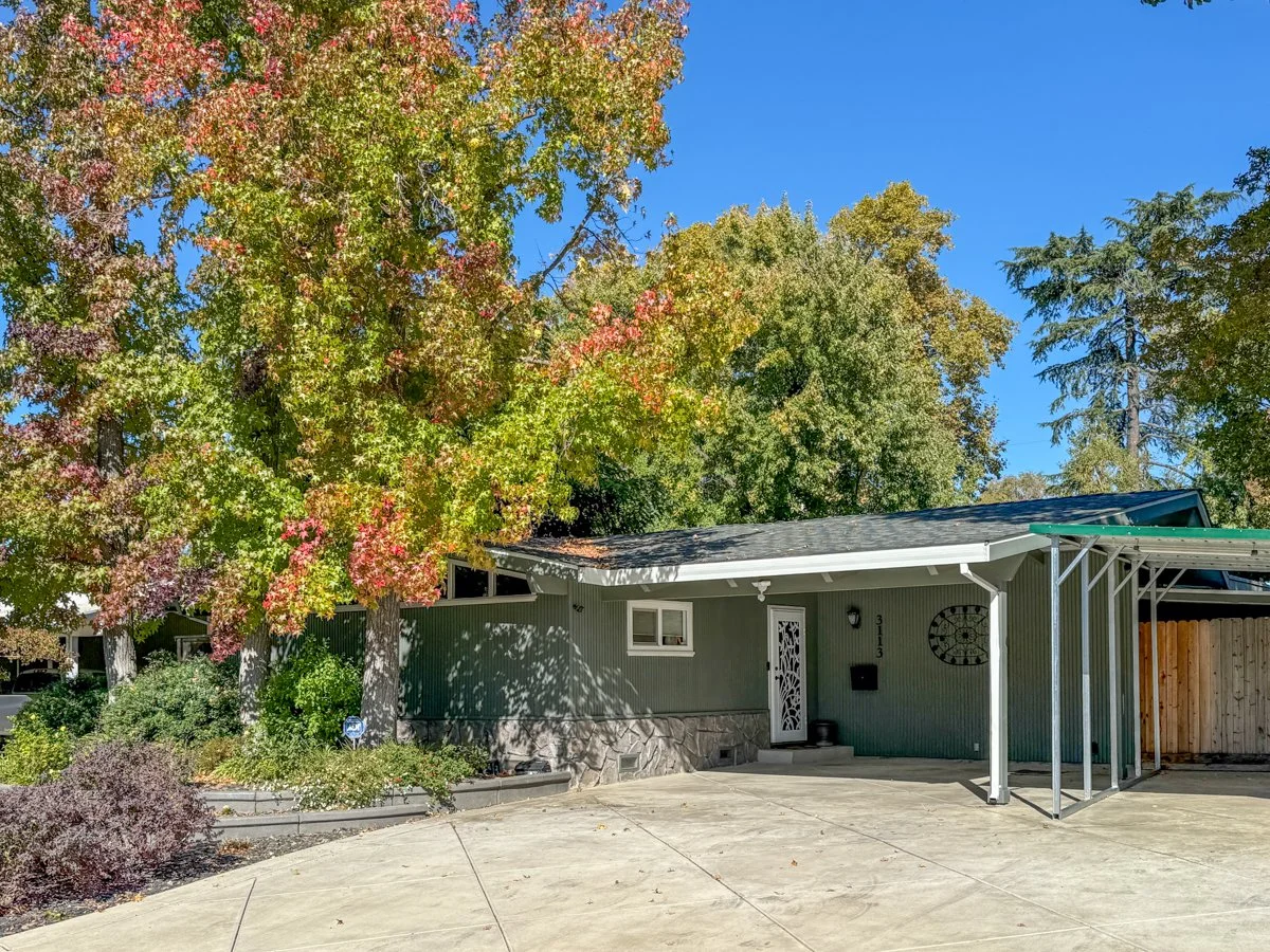 Carport in front and recent driveway hardscape .