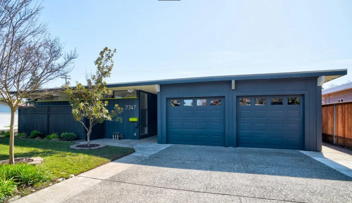 Streng Bros mcm home with flat roof, split two car garage, clerestory windows and flat roof.