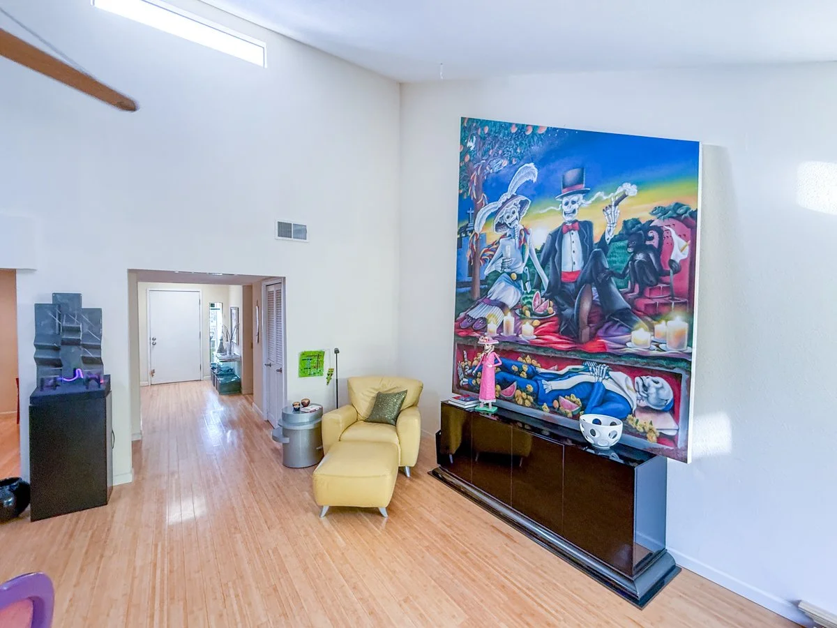 Living room view showing skylight windows and entry way. 