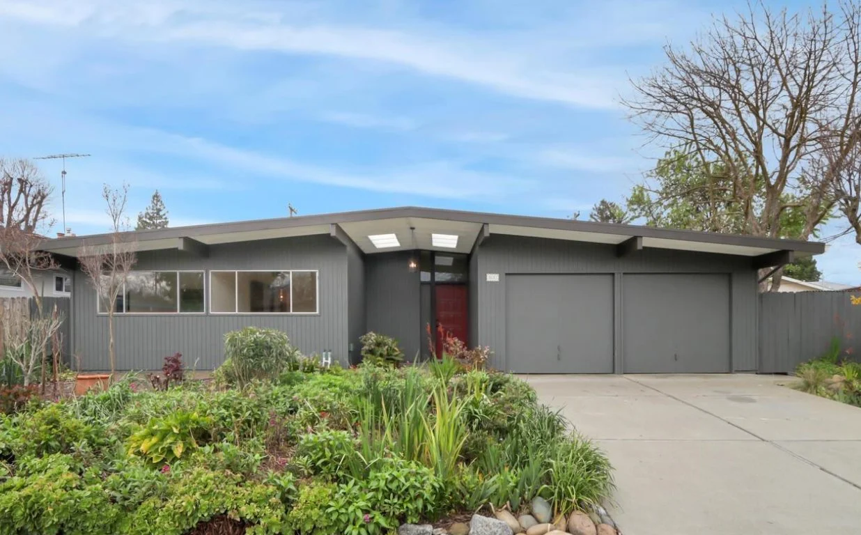 Dark Grey Streng Bros mid century modern home with skylight entry and 2 car garage.