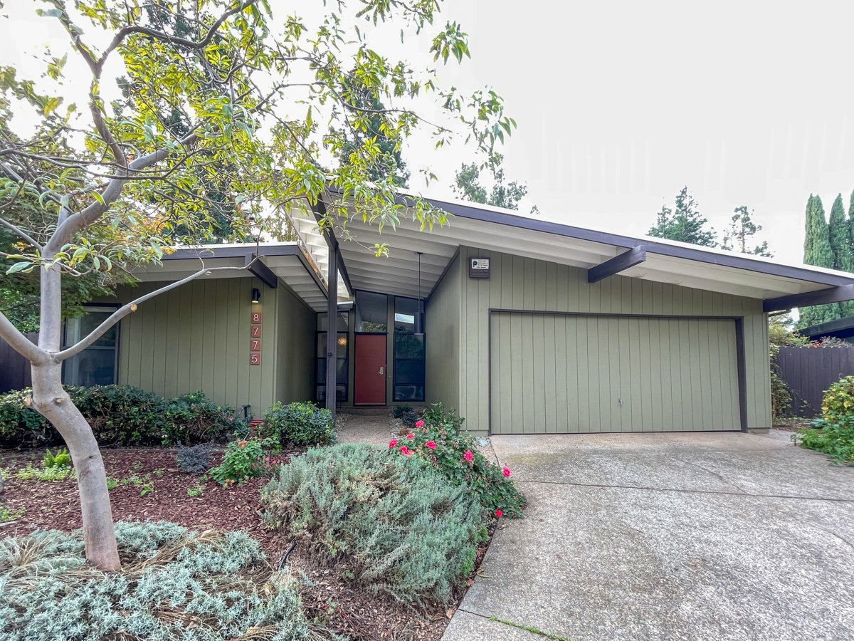 Streng Bros mid century modern home with split gable roof and 2 car garage.