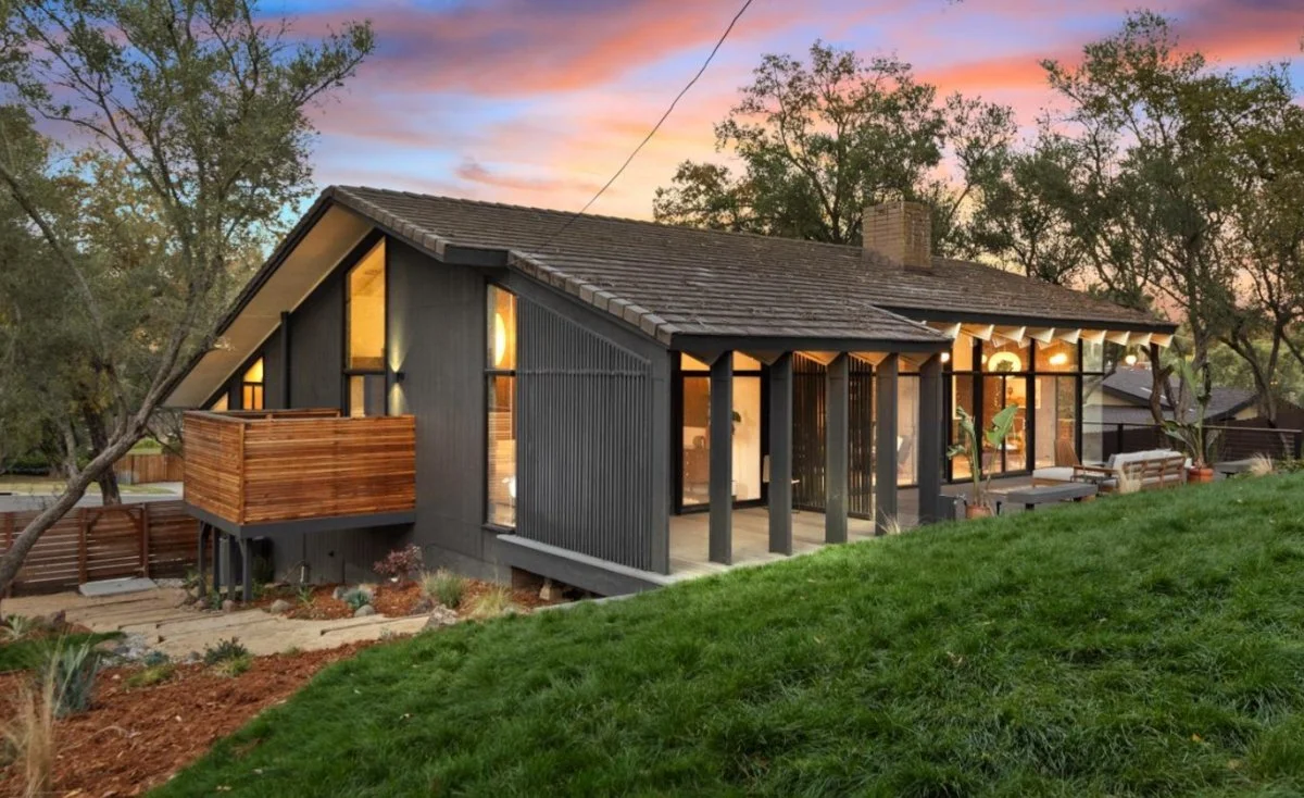 Mid century Modern home with lots of windows and huge balcony.