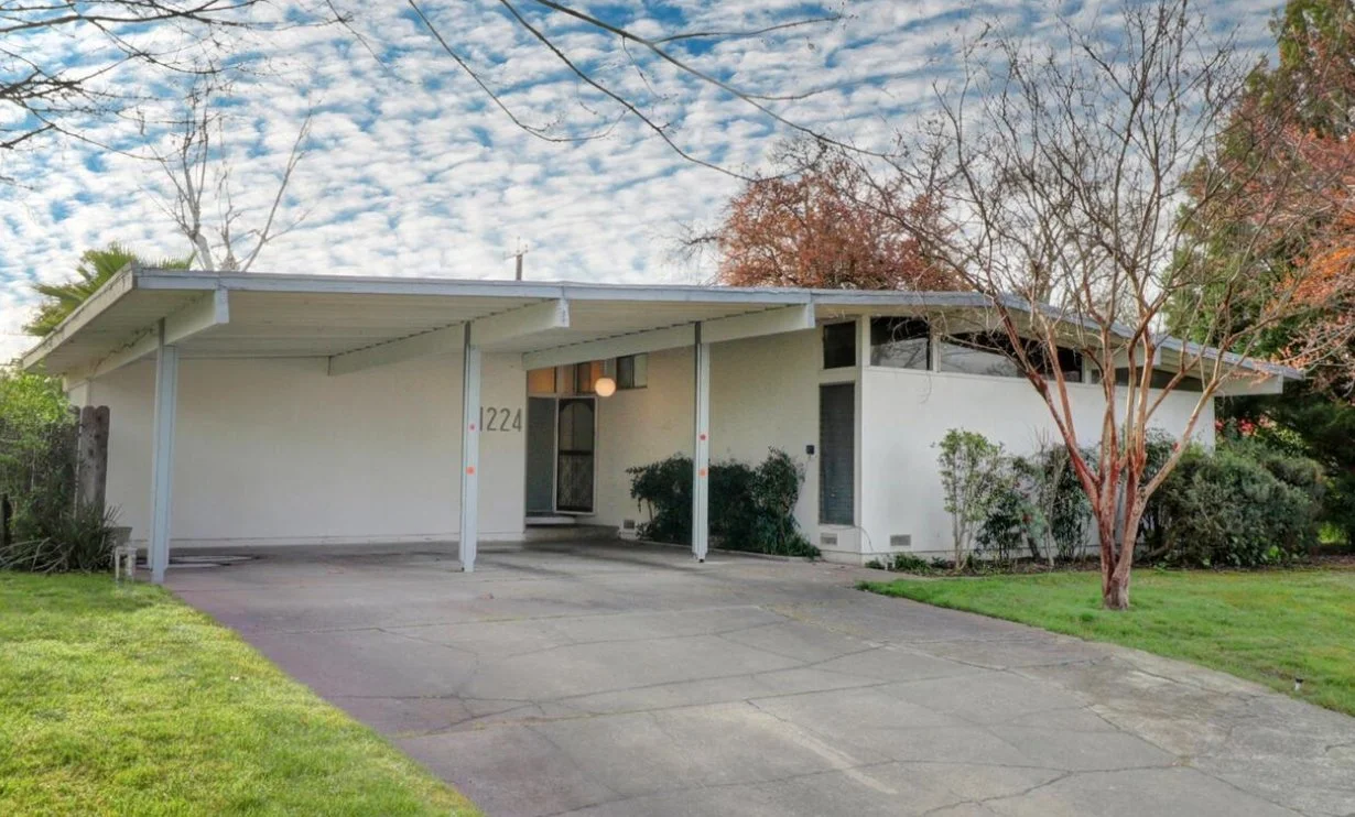 White Post and Beam mid century modern home with carport.