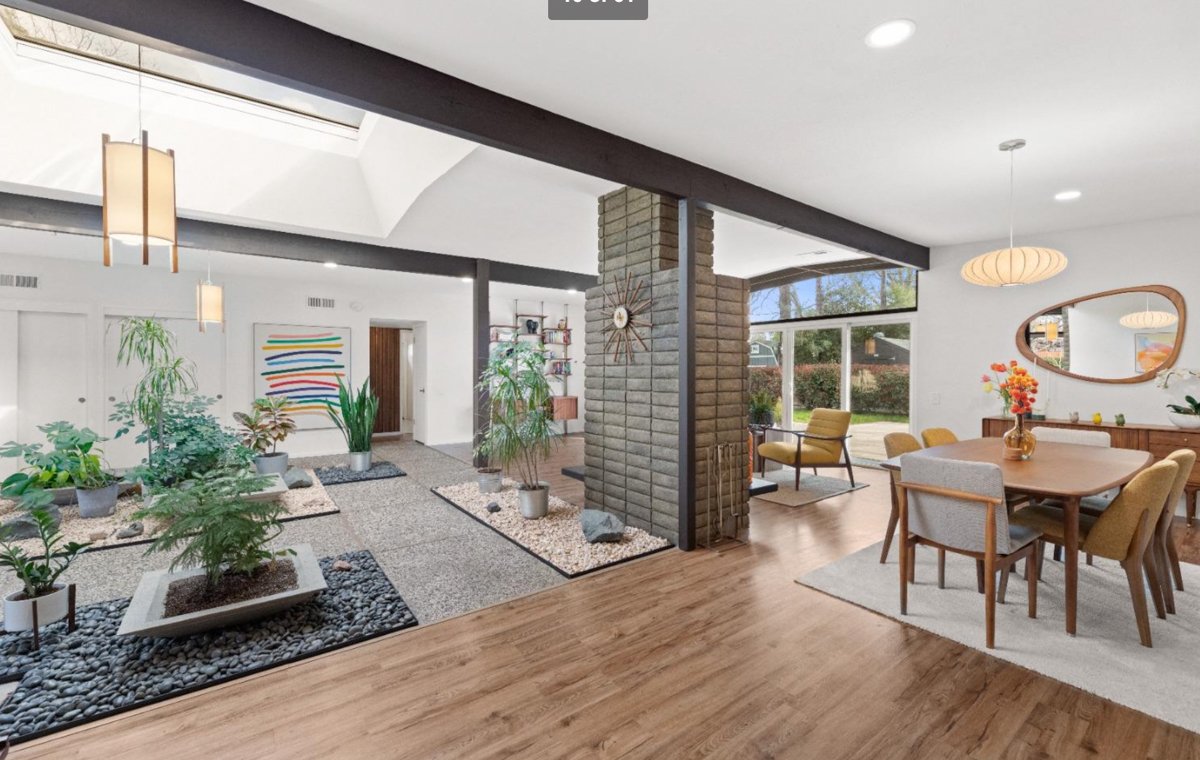 Streng Bros atrium home with central fireplace, open beam ceilings and exposed aggregate floor.