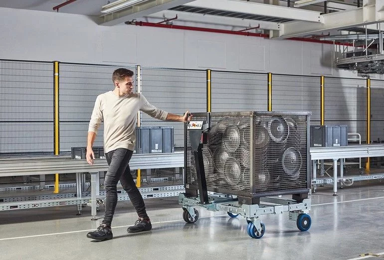 Pallet of packaged products on an automated loading machine in a warehouse.