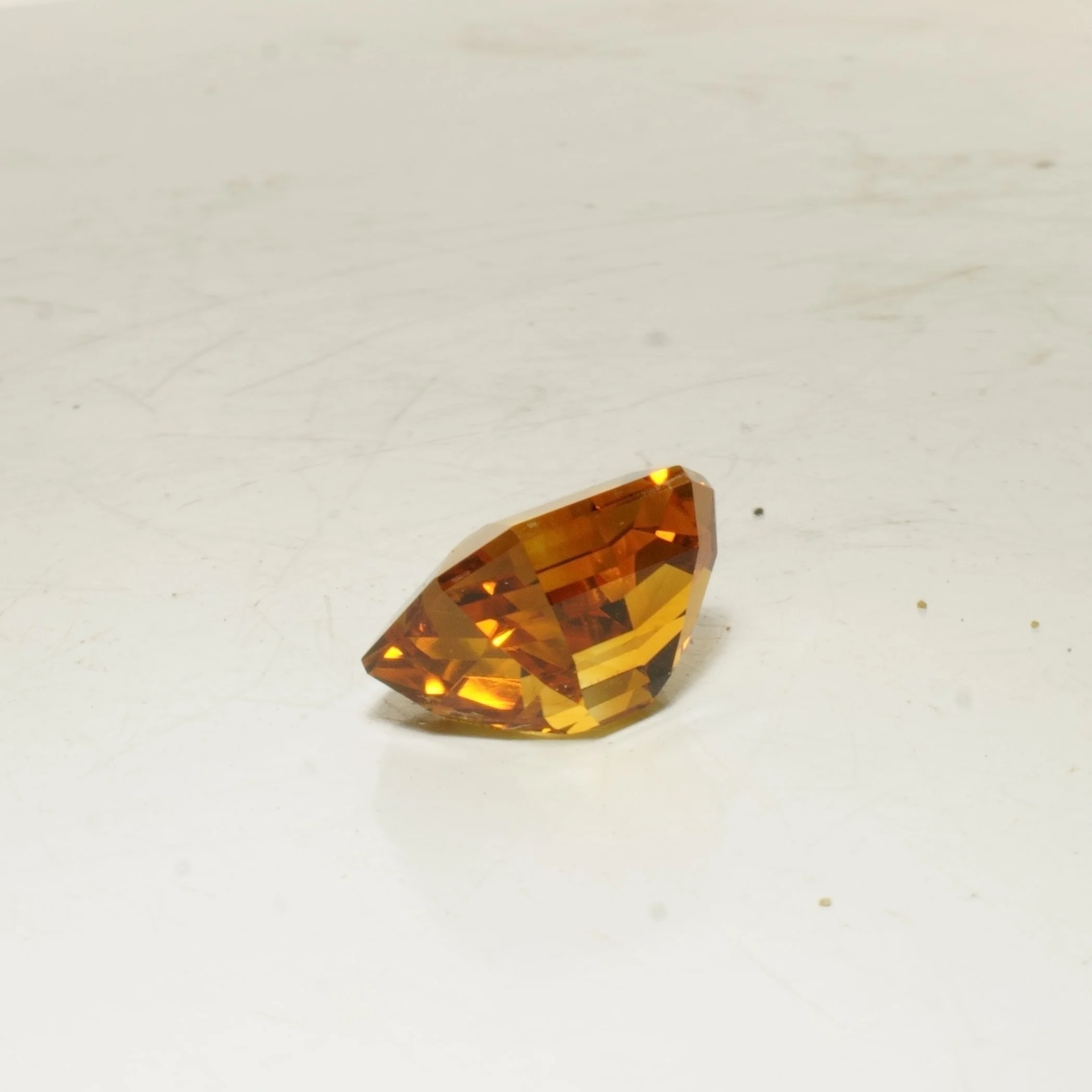 Emerald cut citrine gemstone with golden orange color, faceted rectangular cut, 8.5 carats.