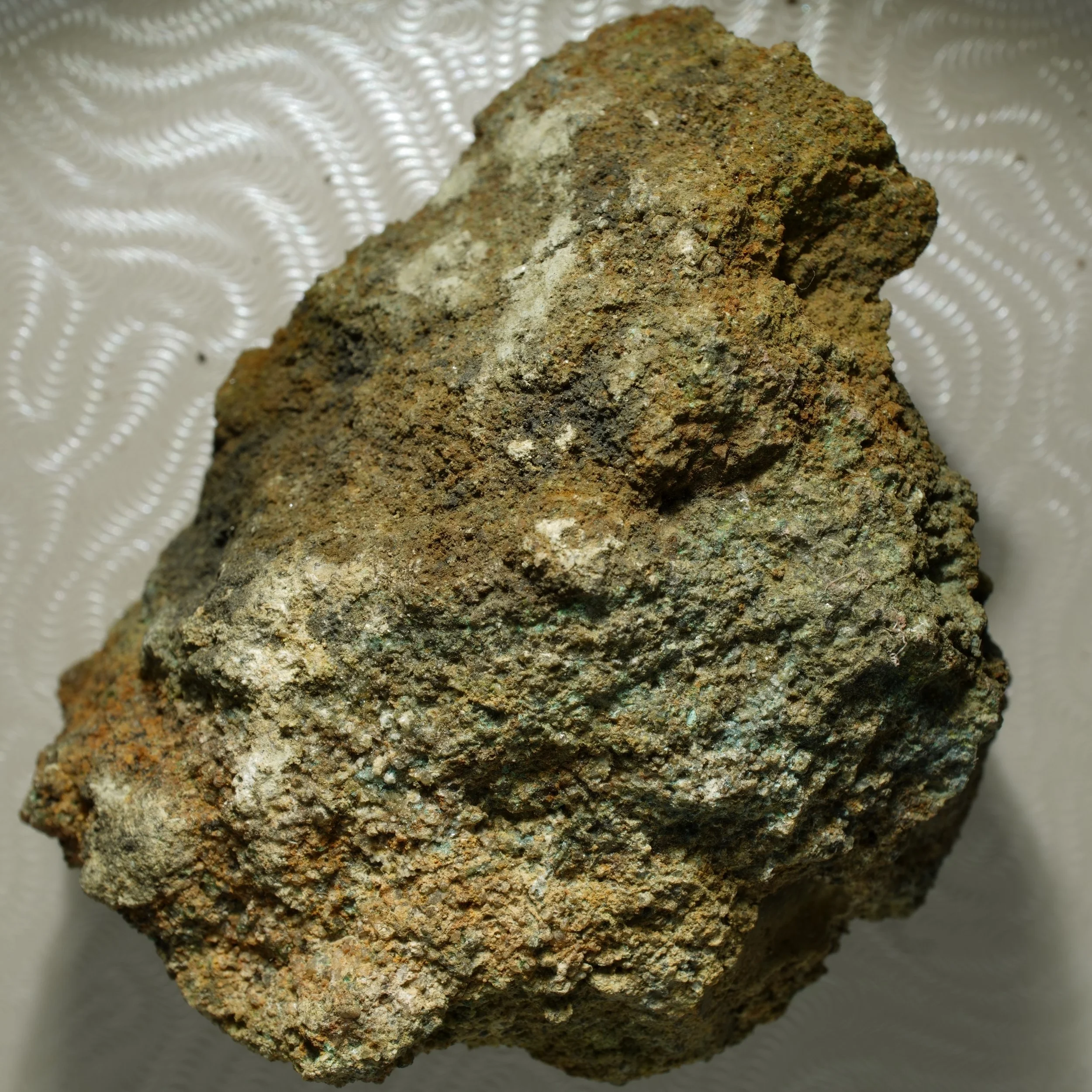 uraninite uranium ore specimen in quartz matrix with green secondary mineralization and strong radioactive activity