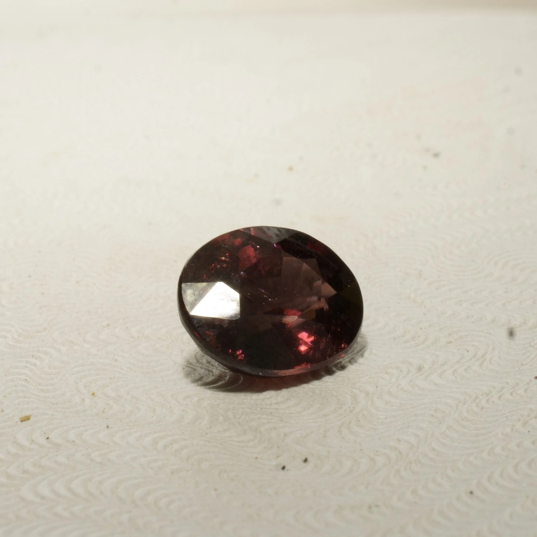 Natural untreated red zircon gemstone, oval faceted cut, 4.5 carats, 10 by 8 by 5 millimeters, VVS clarity.