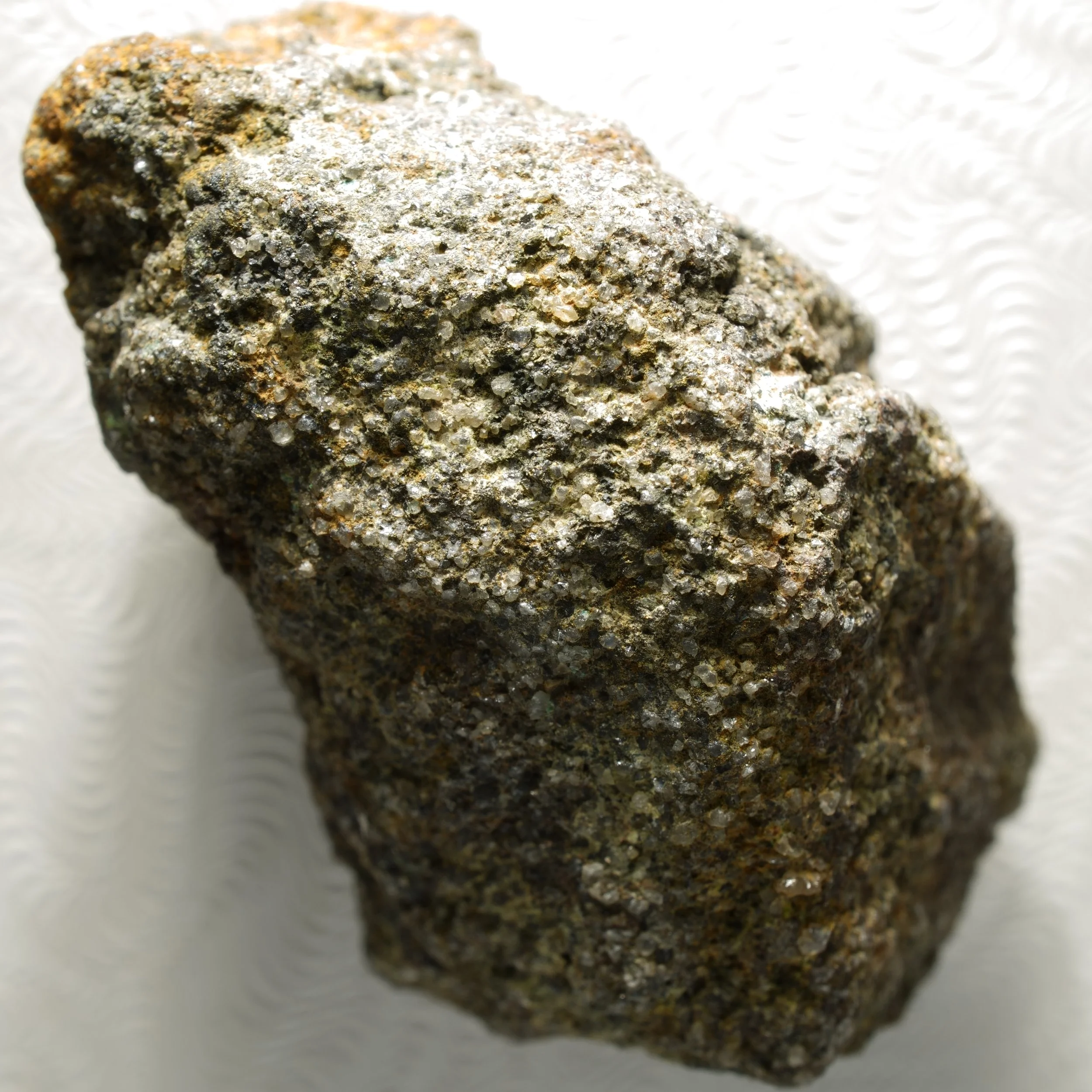 small uraninite uranium specimen in quartz matrix with iron oxide coating compact radioactive mineral sample