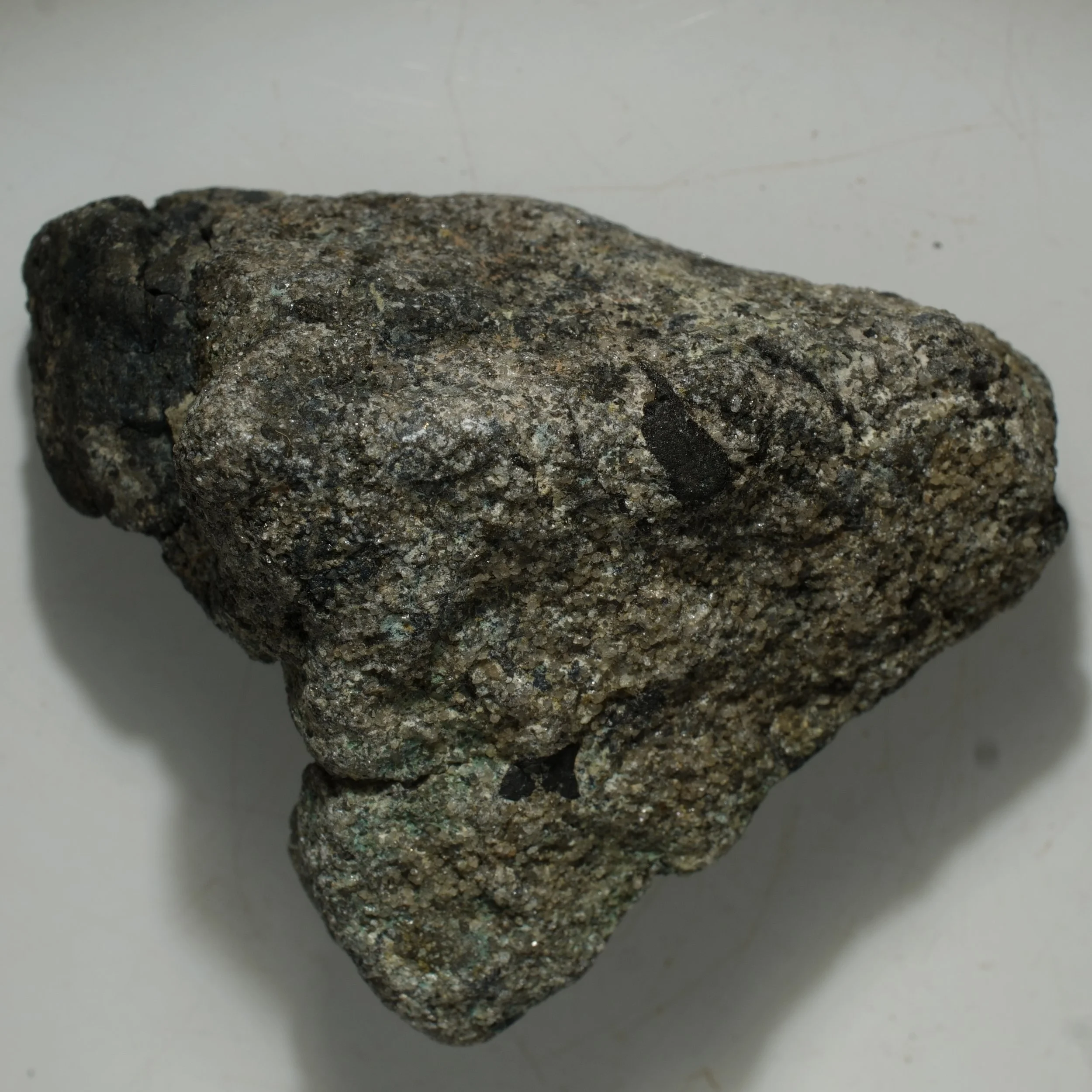 Uraninite uranium ore specimen in quartz matrix with dark primary mineralization and moderate green alteration