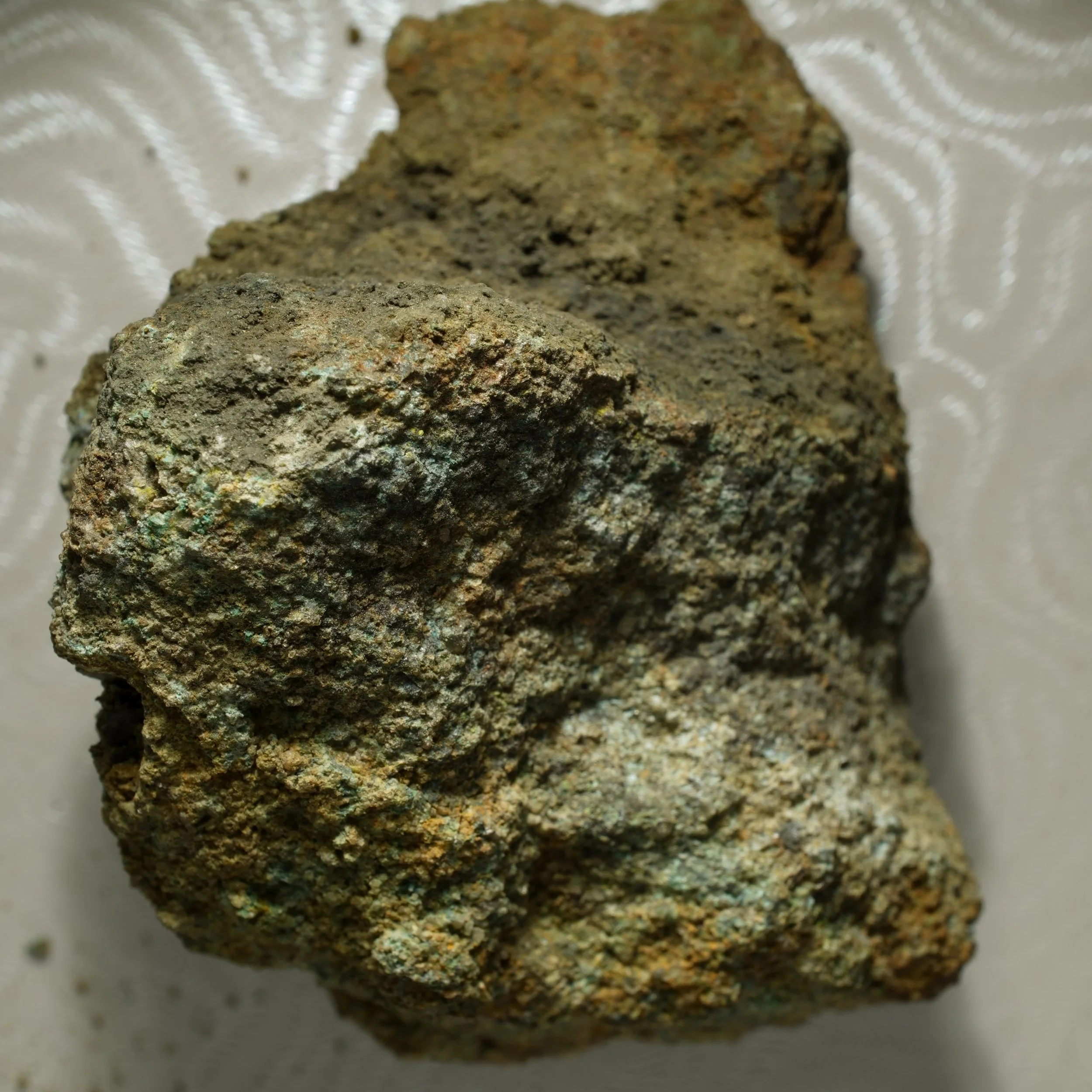 uraninite uranium ore specimen in quartz matrix with green secondary mineralization and strong radioactive activity