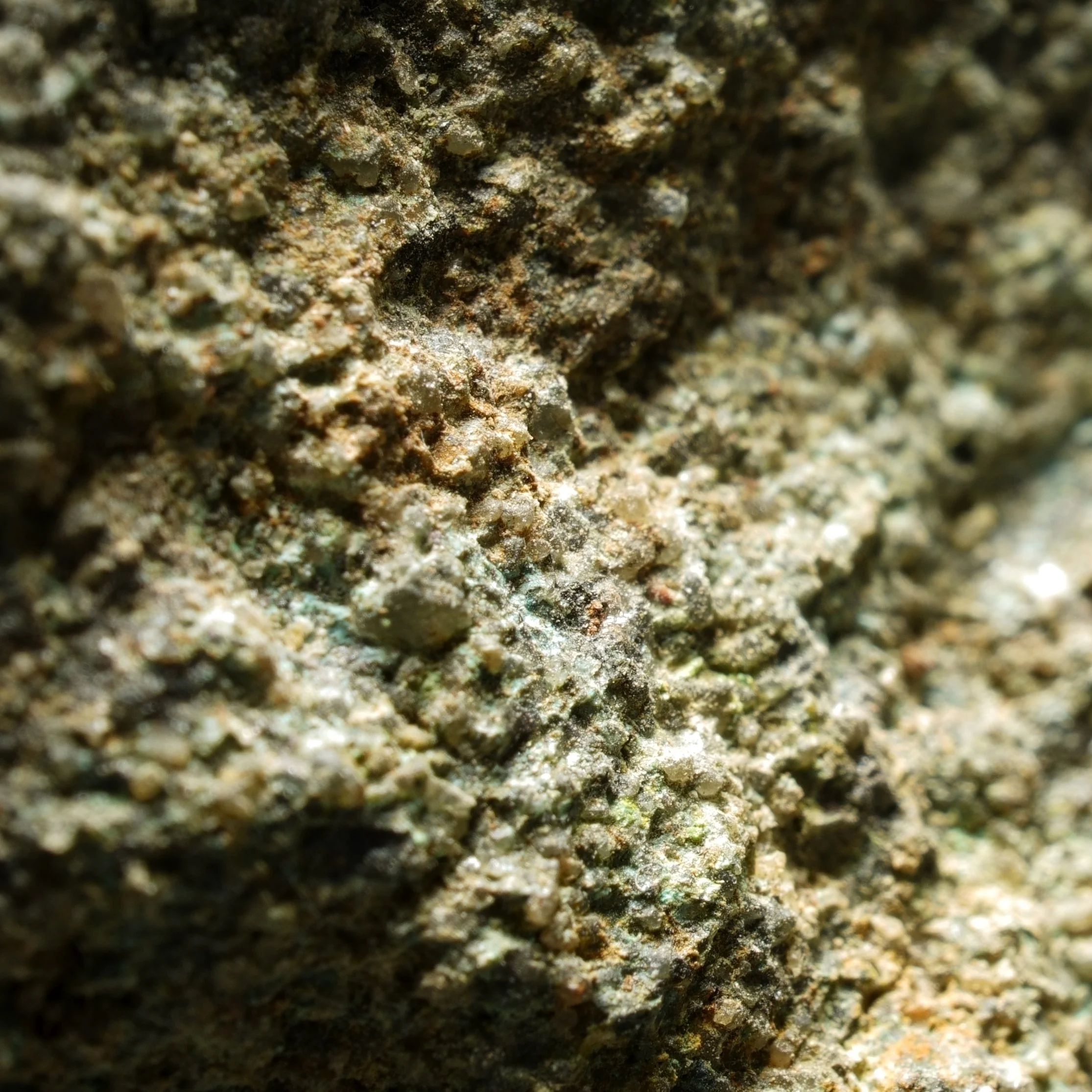 uraninite uranium ore specimen in quartz matrix with green secondary mineralization and strong radioactive activity