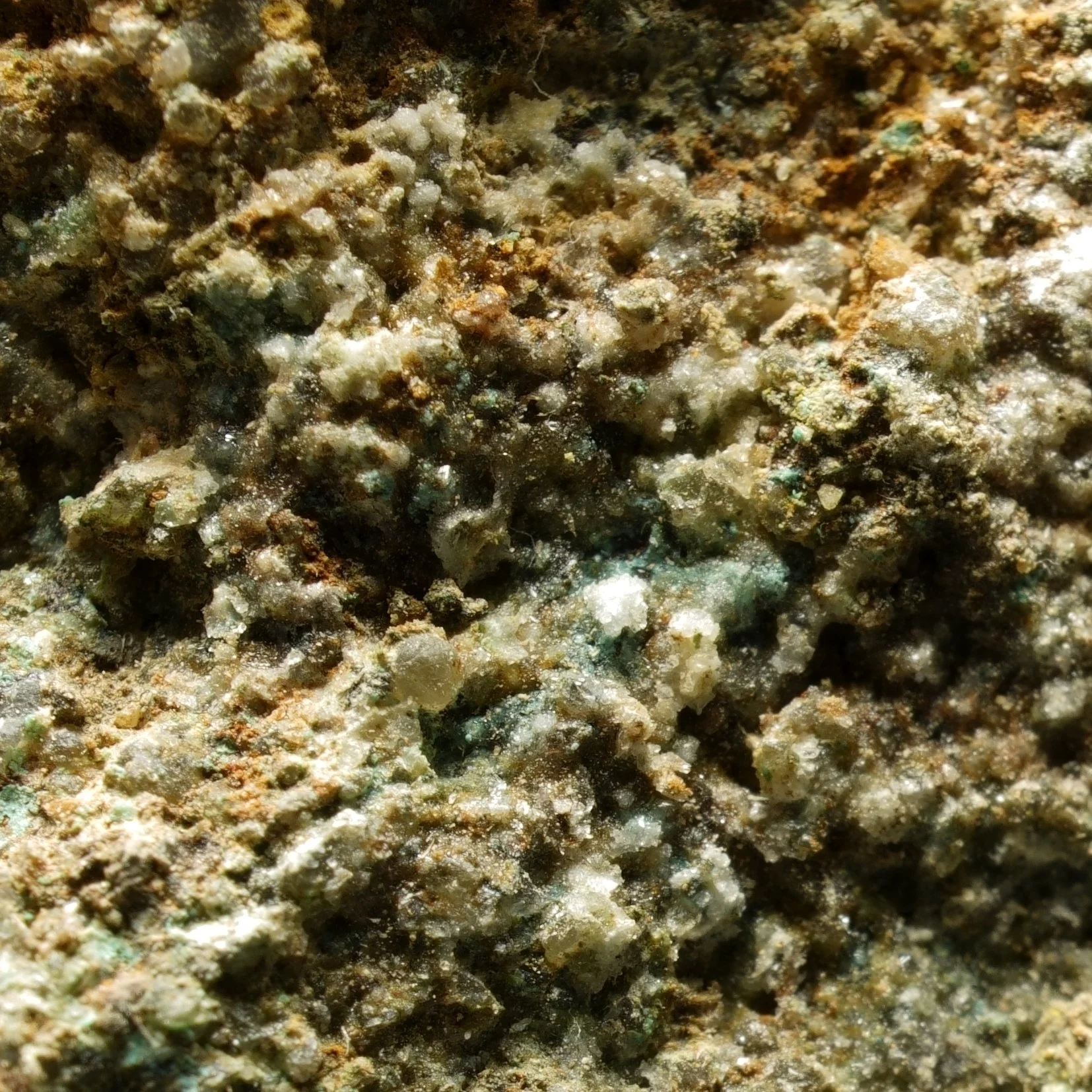 uraninite uranium ore specimen in quartz matrix with green secondary mineralization and strong radioactive activity