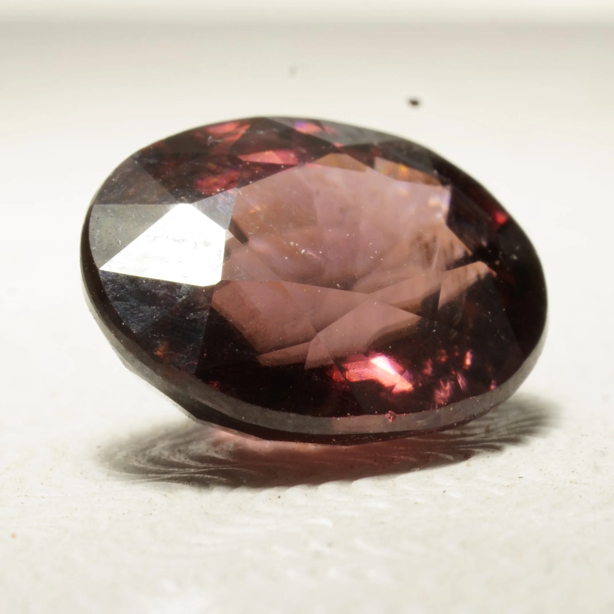 _Natural untreated red zircon gemstone, oval faceted cut, 4.5 carats, 10 by 8 by 5 millimeters, VVS clarity.