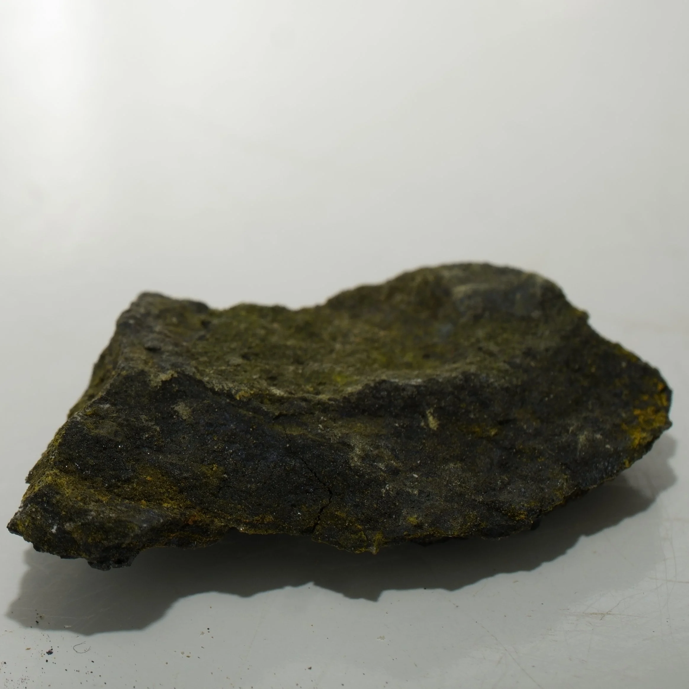 Micro uranium ore specimen from Cottonwood Wash Utah with dark uraninite-rich material emitting 30,000 CPM