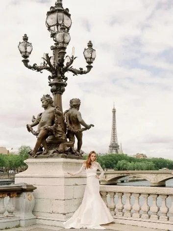 Bliss Monique Lhuillier BL24104 &mdash; 50% off. This Monique Lhuillier corset bodice trumpet gown with embroidered lace a silk mikado is a true classic. Shown here styled with the coordinating embroidered long sleeve lace jacket, ask your bridal sty