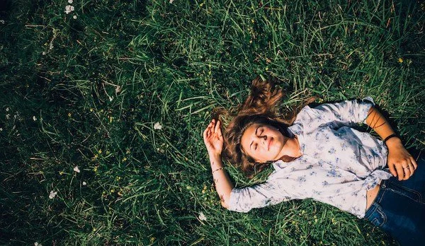 woman lying down in the grass