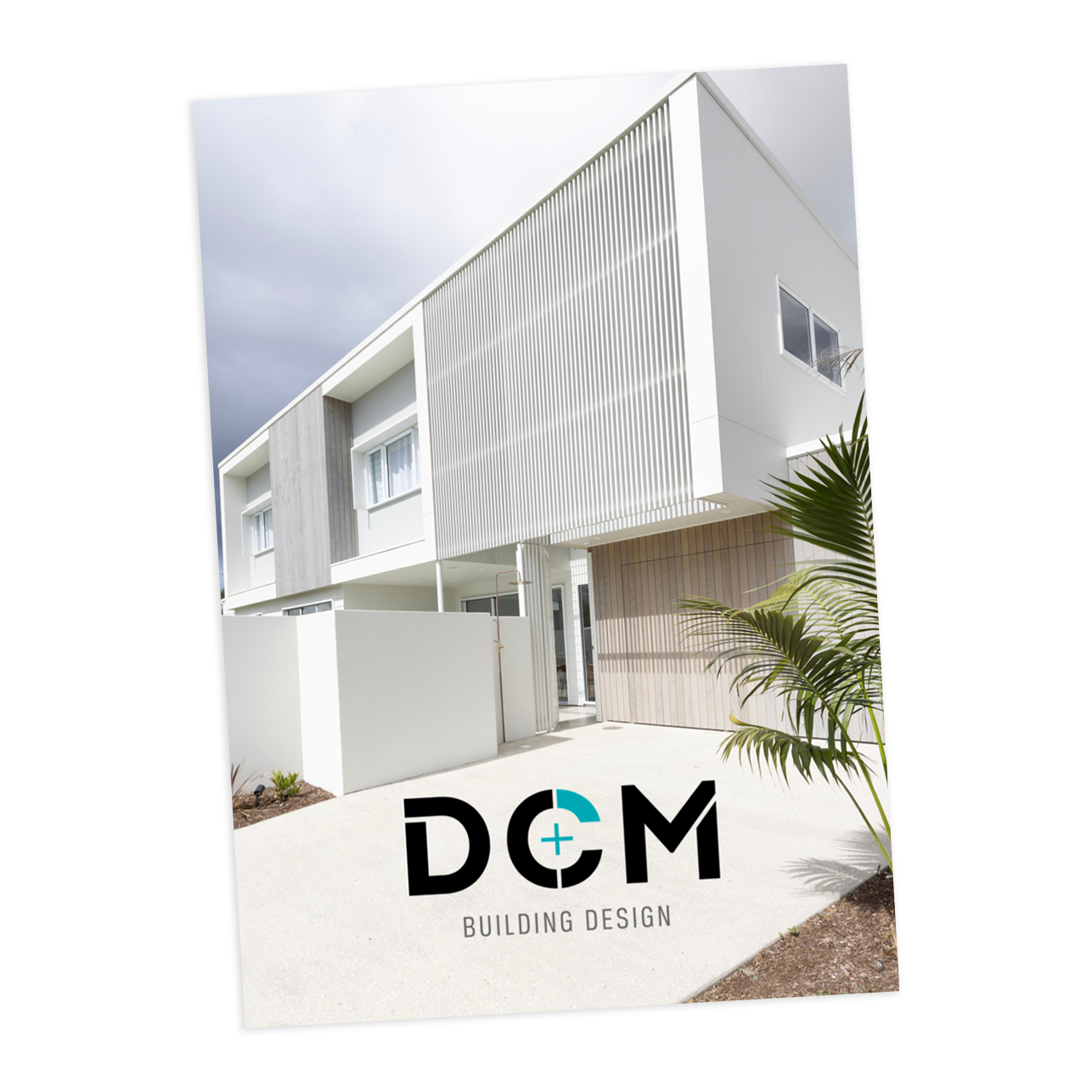 Modern two-story house with a minimalist design, featuring a white and gray exterior, vertical slats, and a small palm tree in front. The image includes the logo and text "DCM Building Design."