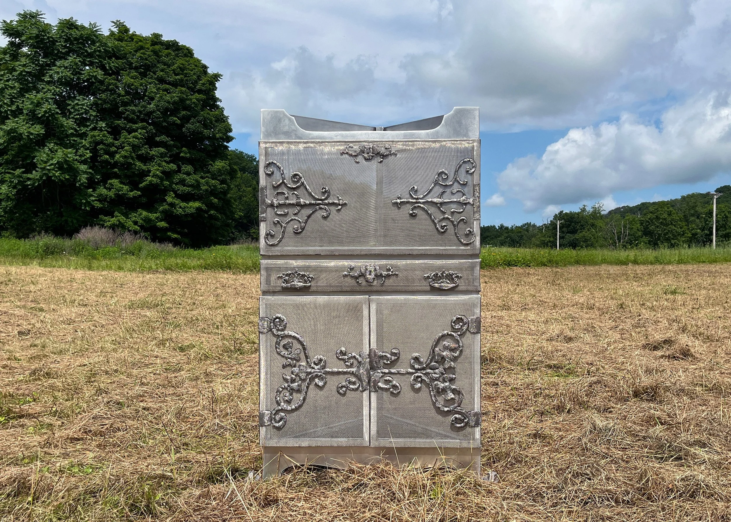 "A Corner"
aluminum, mild steel, stainless steel
2025,    48” x 28” x 17”

A phantom of an original family heirloom corner cabinet, this sculpture reflects on our desire to cherish and preserve while facing the inevitability of change and life cycles