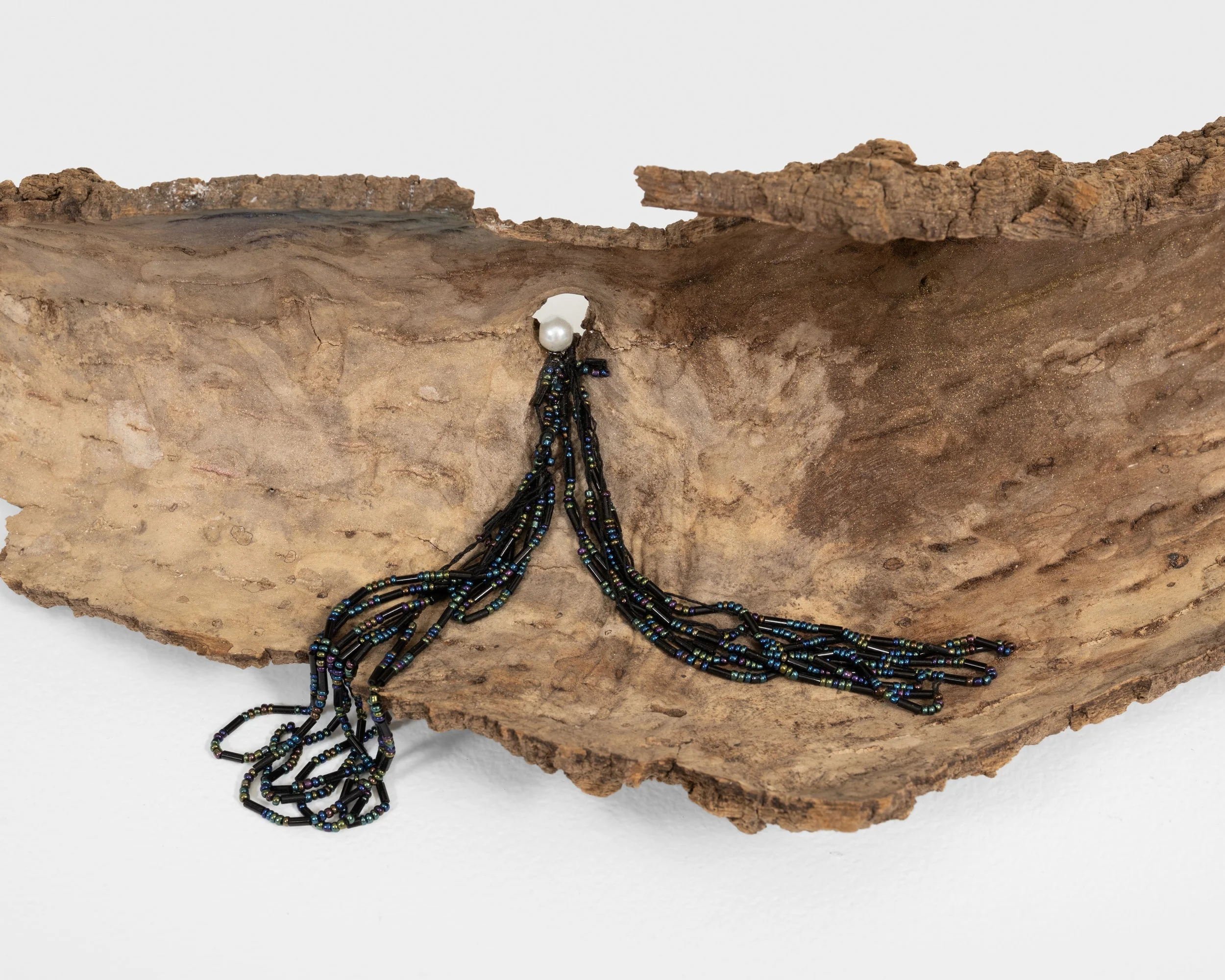 We Will Never Meet 
found tree bark, plastic pearl, beads, string, seashell, mica powder 
2021, 5" x 25" x 10" 