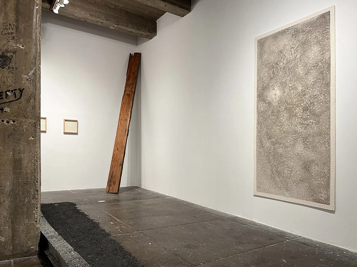 Installation view with cedar plank and large scale wall piece