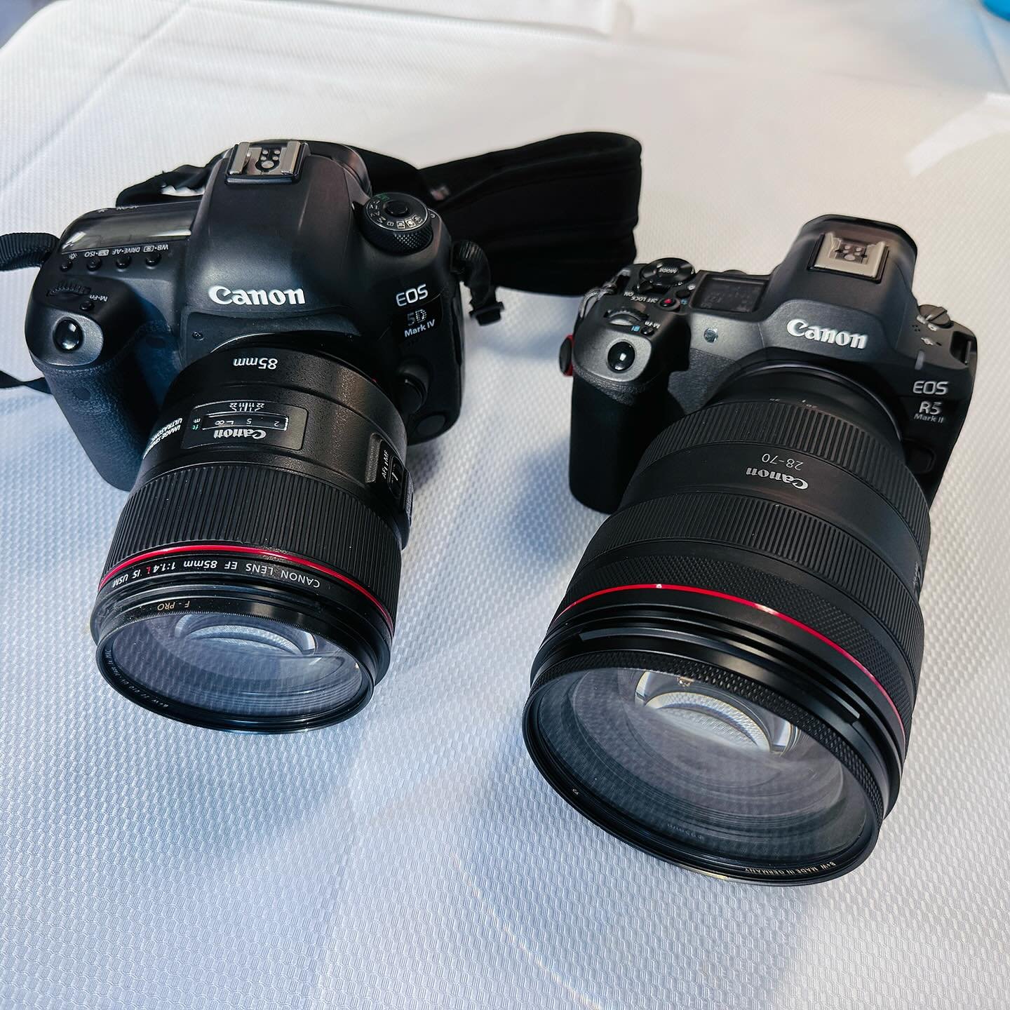Check it out. I was shooting an event recently and a buddy of mine showed up with his DSLR setup. Here we have his Canon EOS 5D Mark4 with the EF 85mm and my EOS R5 Mark2 with the massive RF 28-70mm f2. You know what now that I&rsquo;m seeing both se