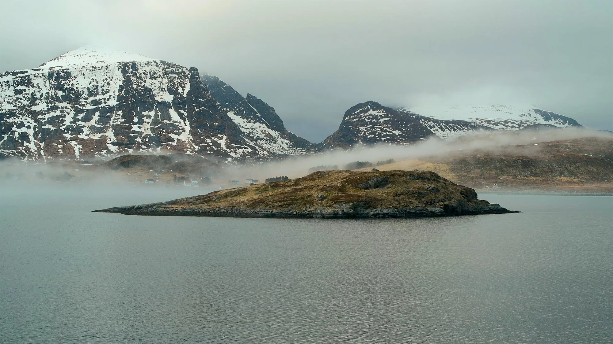 Misty mountains and calm water in Lofoten, Norway, featured in the Drifting Serenity 3-hour calming piano video by Dean Best.