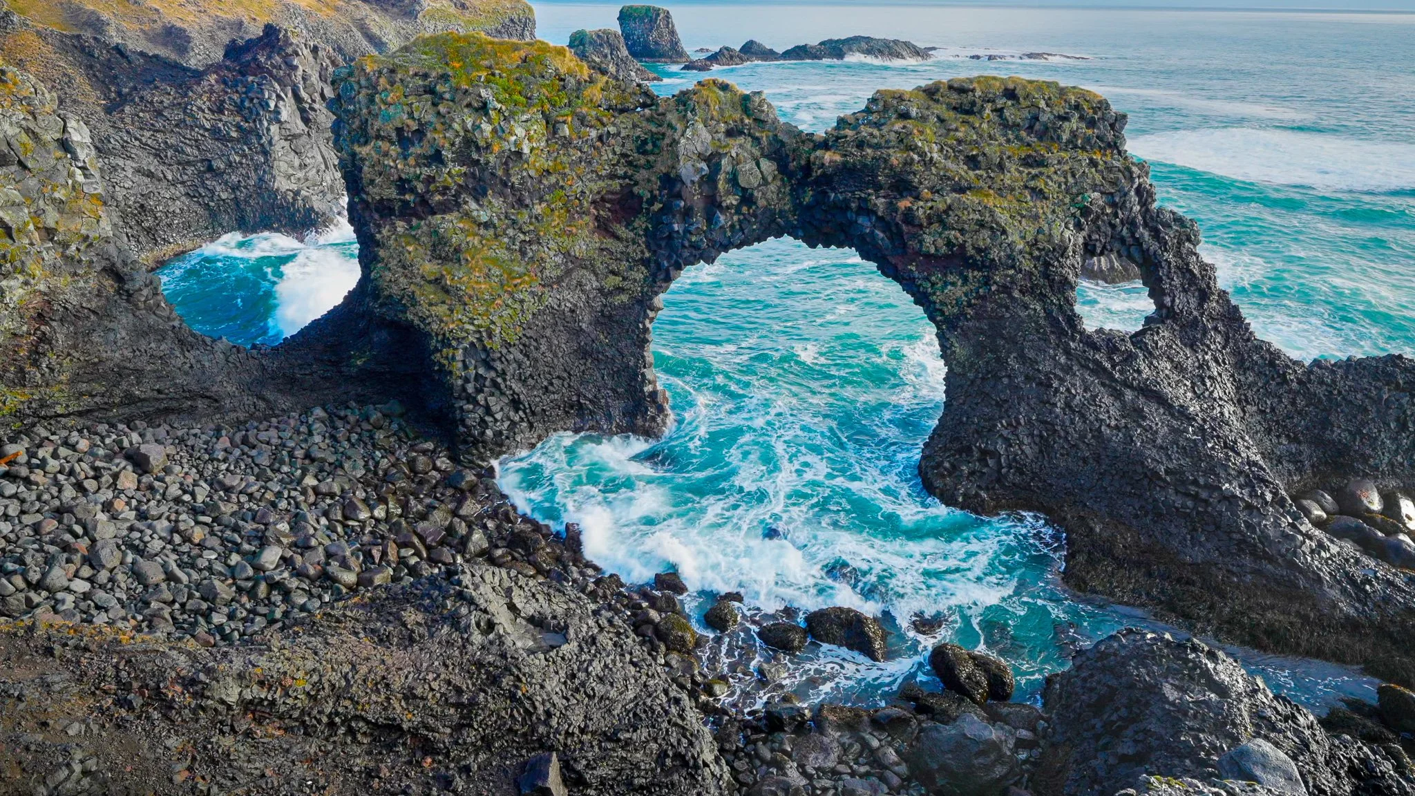 Ocean waves rolling through a rugged sea arch in Iceland, featured in the Eternal Strength 3-hour calming piano video by Dean Best.