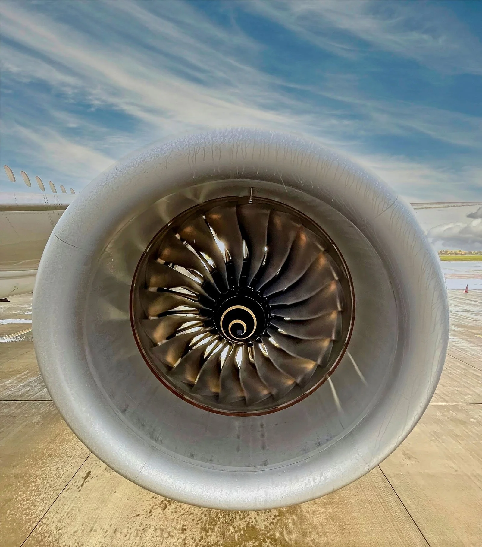 Close-up of a modern airplane engine turbine with raindrops at Schiphol Airport, captured by Dean Best — part of the Relax With Dean collection.