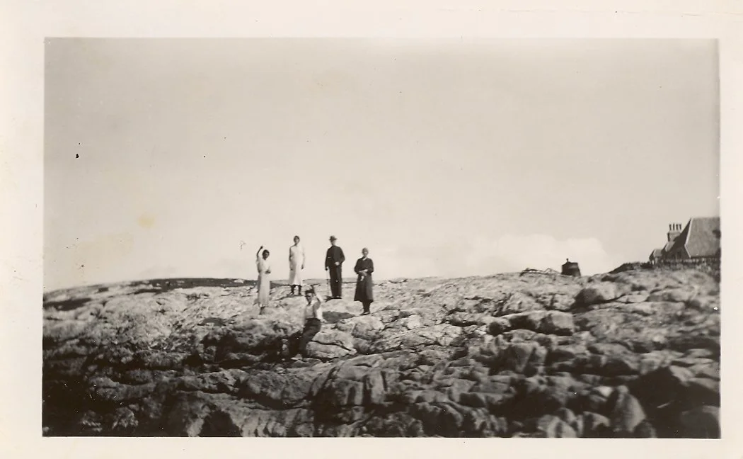 People wave from the shoreline at Rushgarry