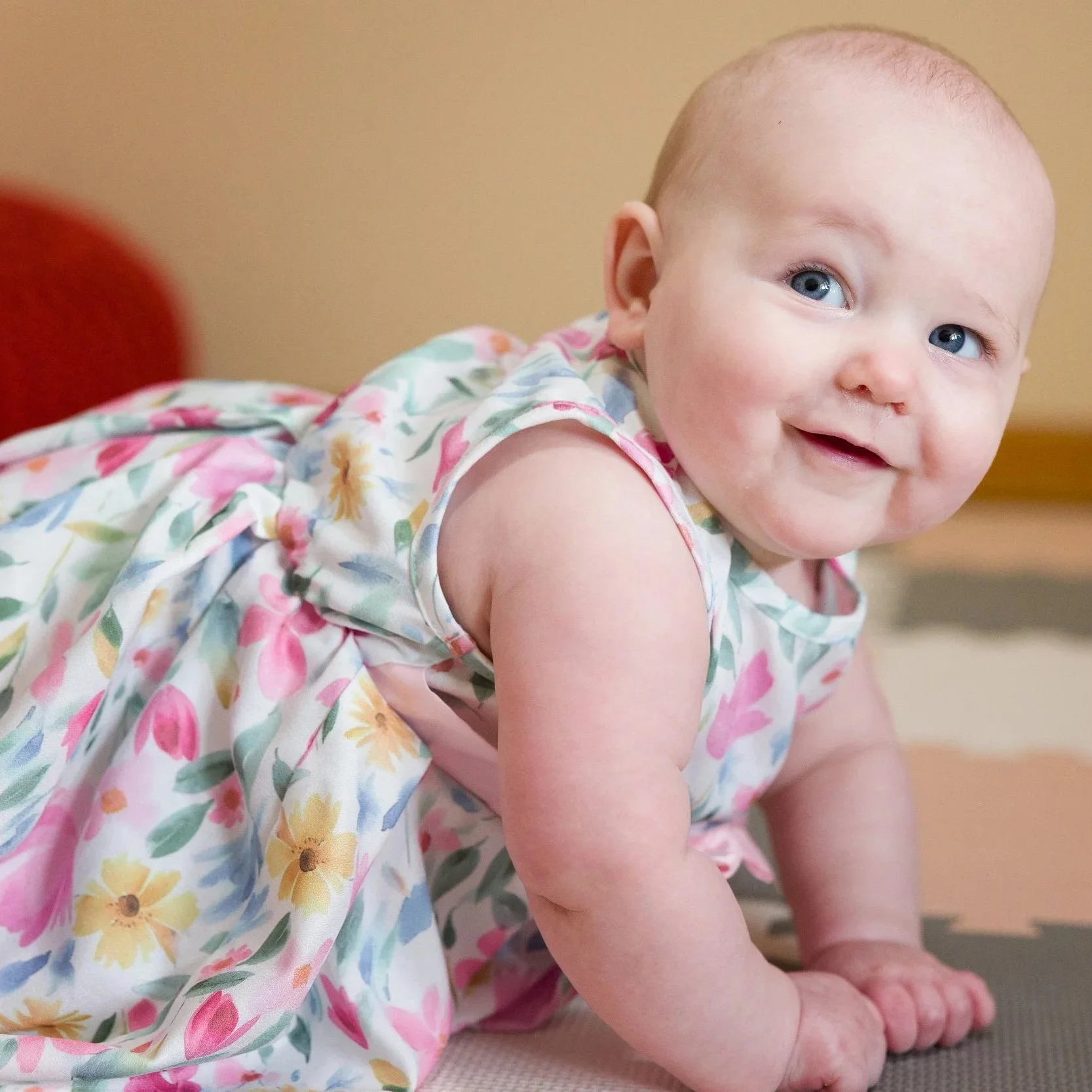 Baby portrait in floral dress during a family photography session